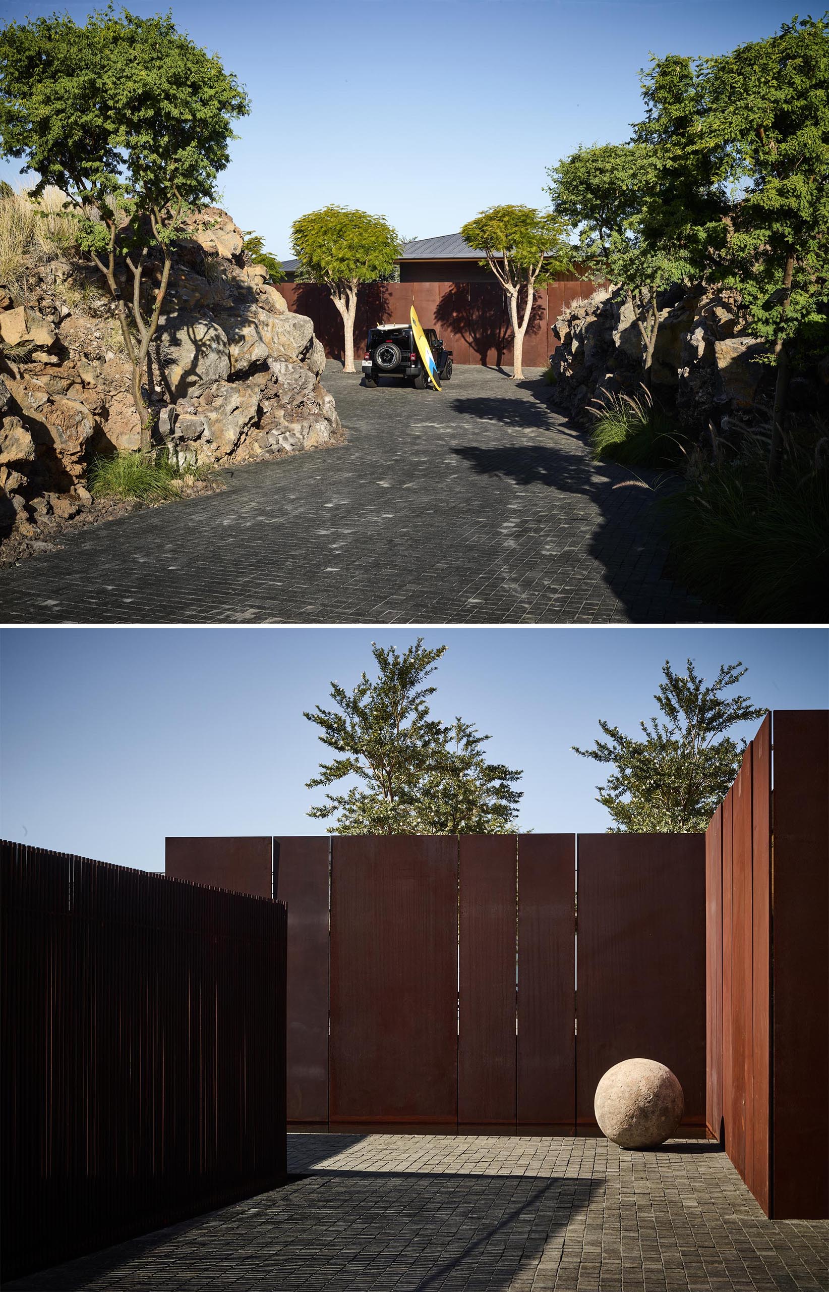 A driveway that leads to a auto court with weathered steel walls.