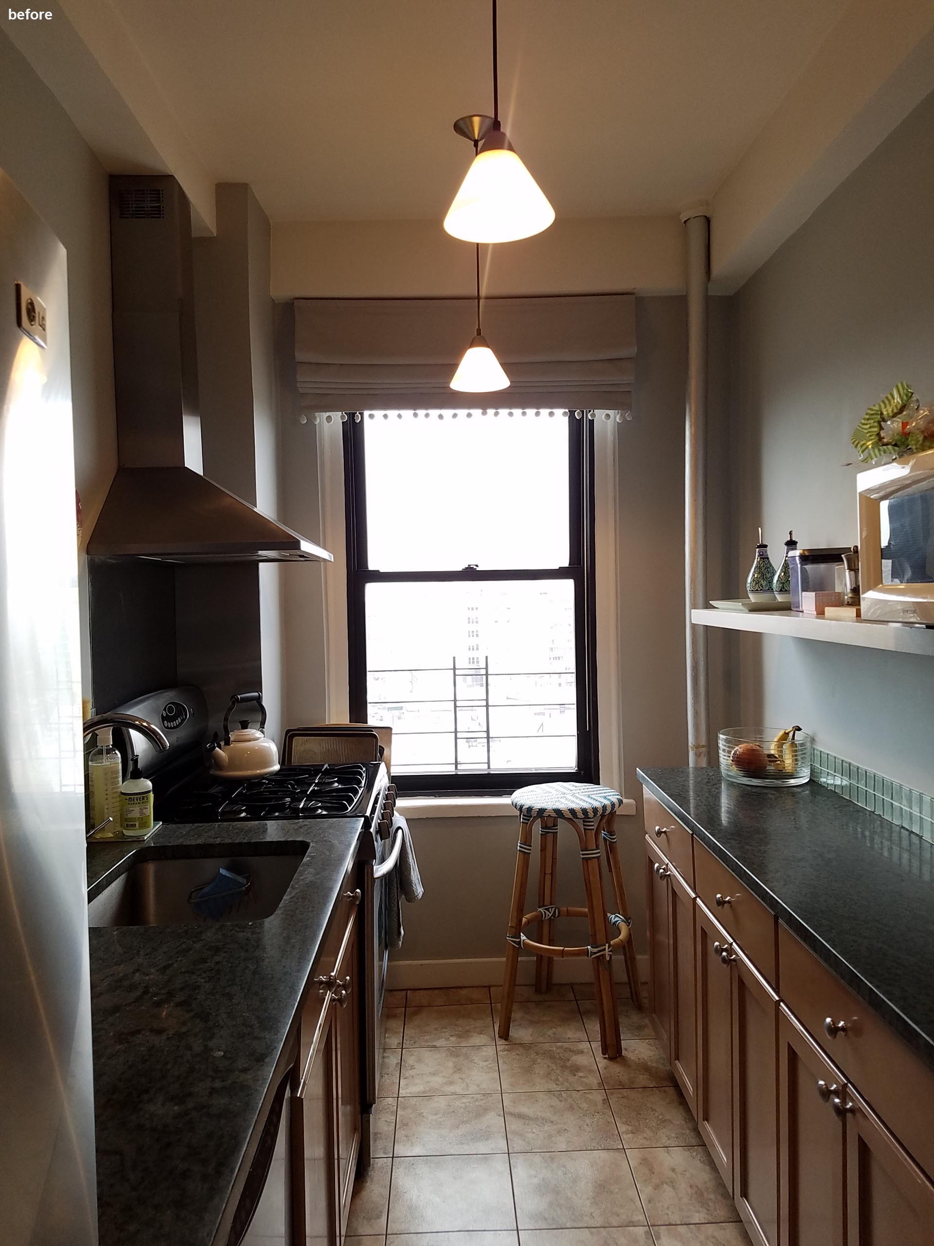 Before photo - a small kitchen with wood cabinets and a dark countertop.