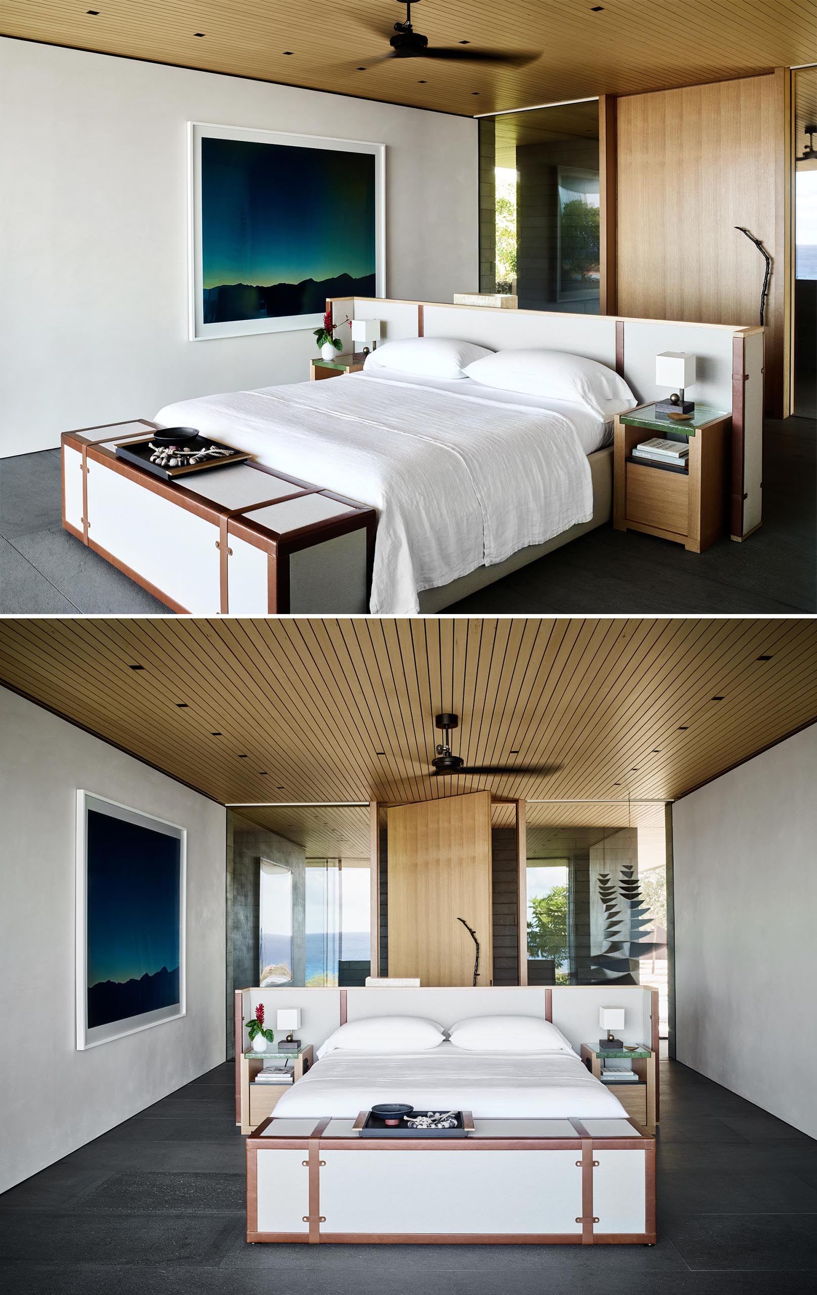 In this modern master bedroom, the bed frame has been centrally positioned in the room to take advantage of the views. There's also a hidden television at the end of the bed, and behind the headboard, there's a desk.