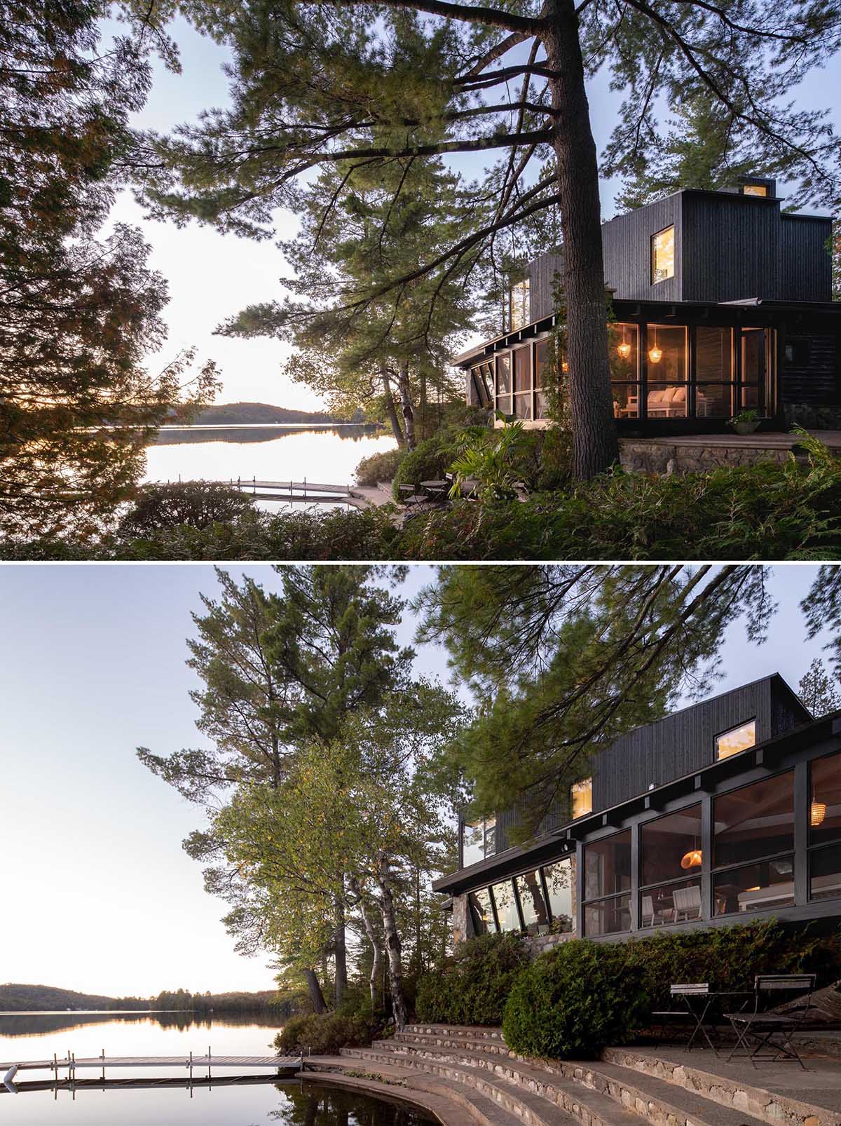 A log cabin with a stone foundation has a modern extension and screened-in porch.