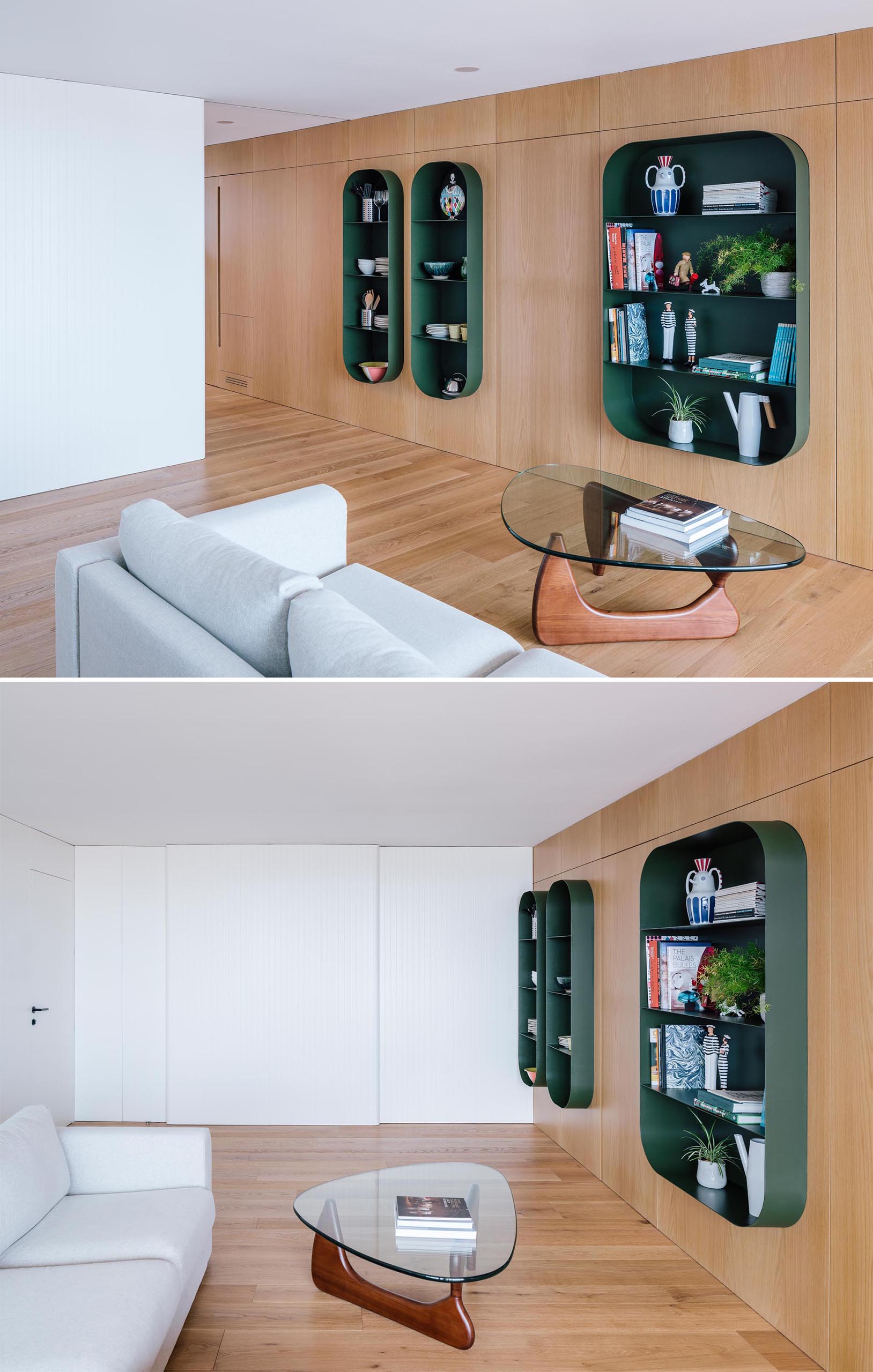 A wood wall that includes hidden storage and partially embedded dark green shelves.