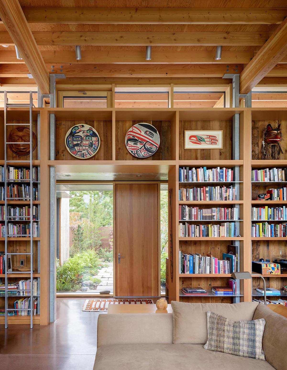 A modern cabin with wood shelving and 16ft high ceilings.