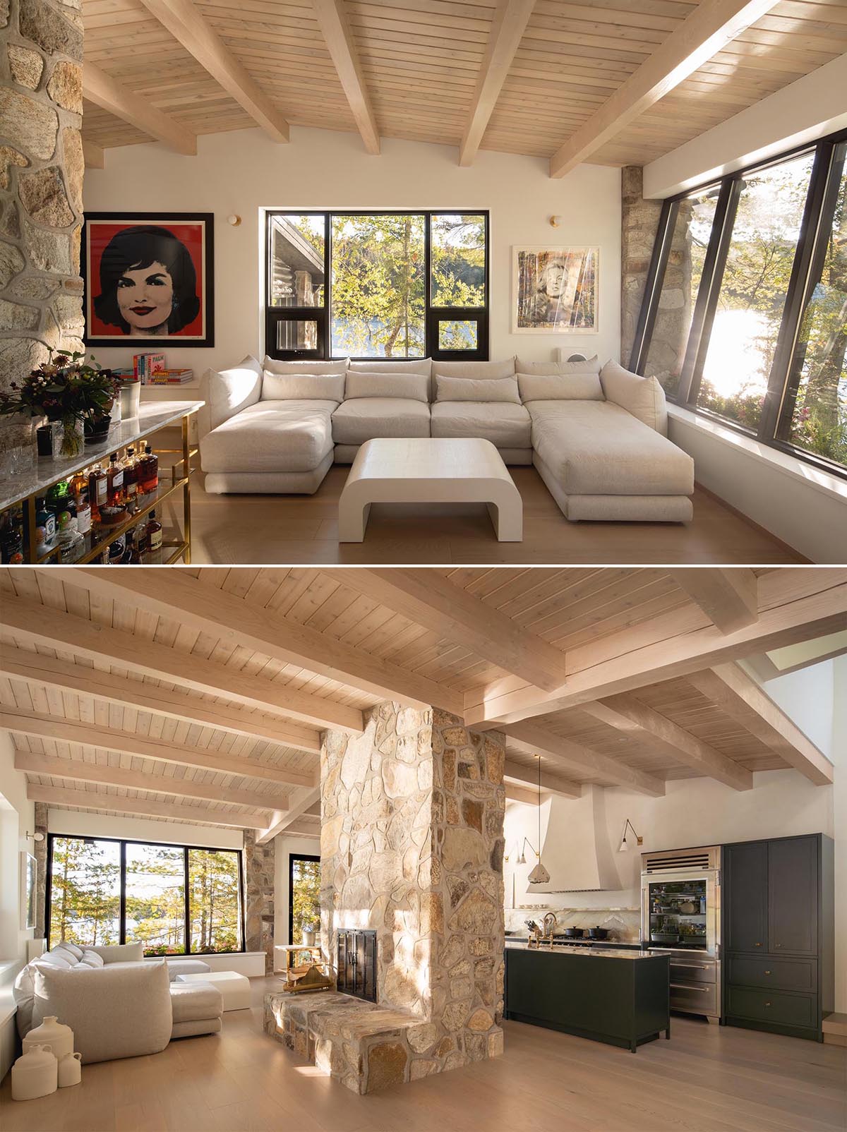 This modern living room in a cabin has a U-shaped sofa that takes advantage of the window views, and a stone fireplace surround.