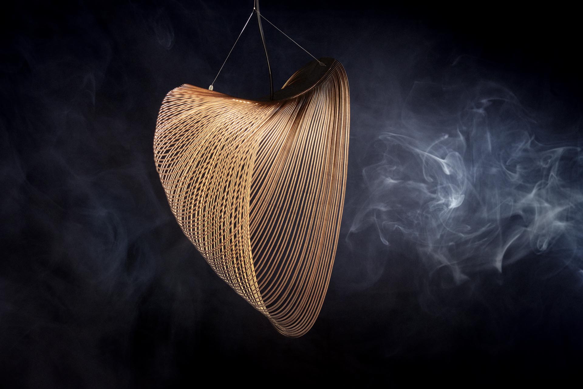 A delicate and sculptural pendant light made from laser cut wood and LEDs.