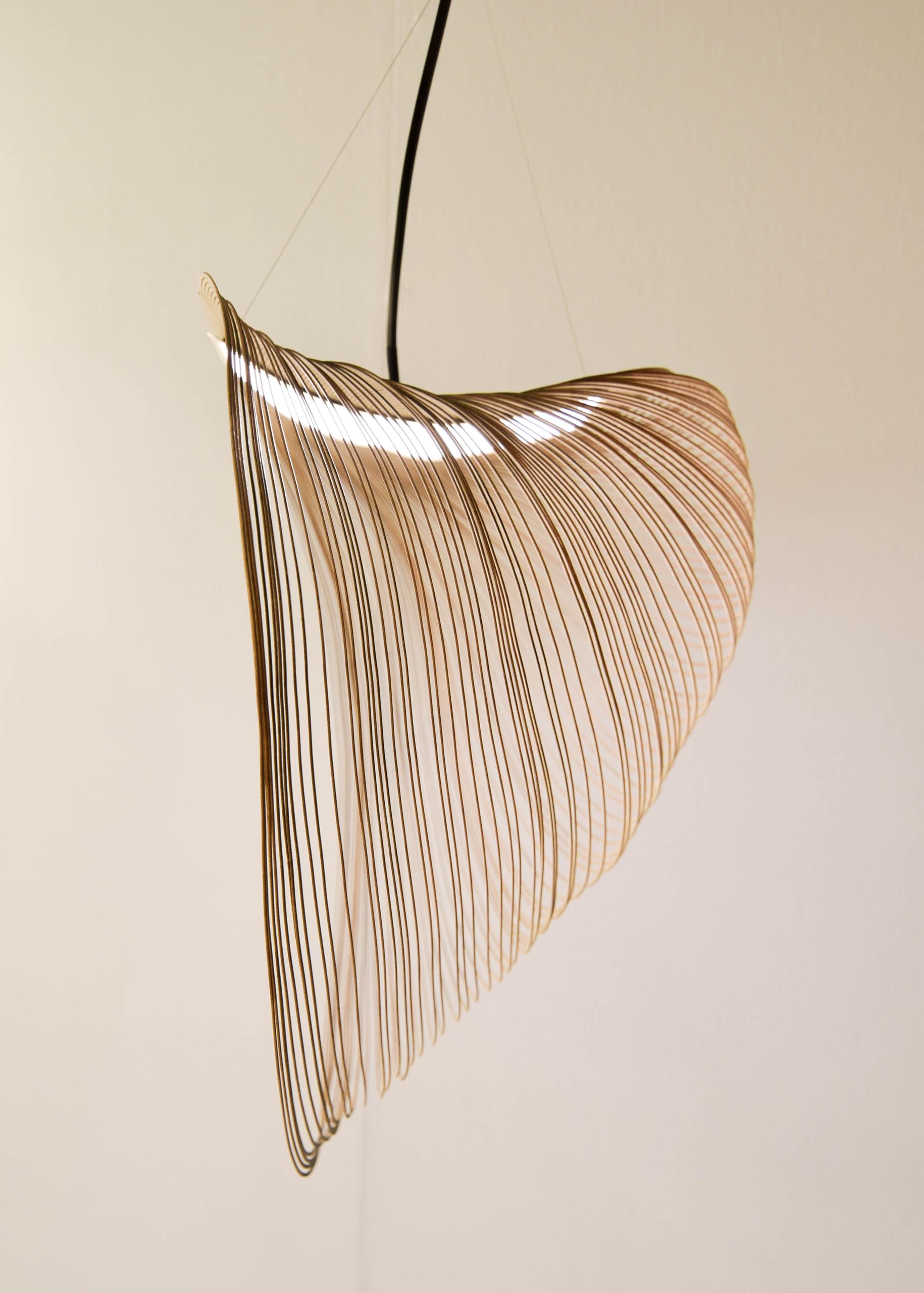 A delicate and sculptural pendant light made from laser cut wood and LEDs.