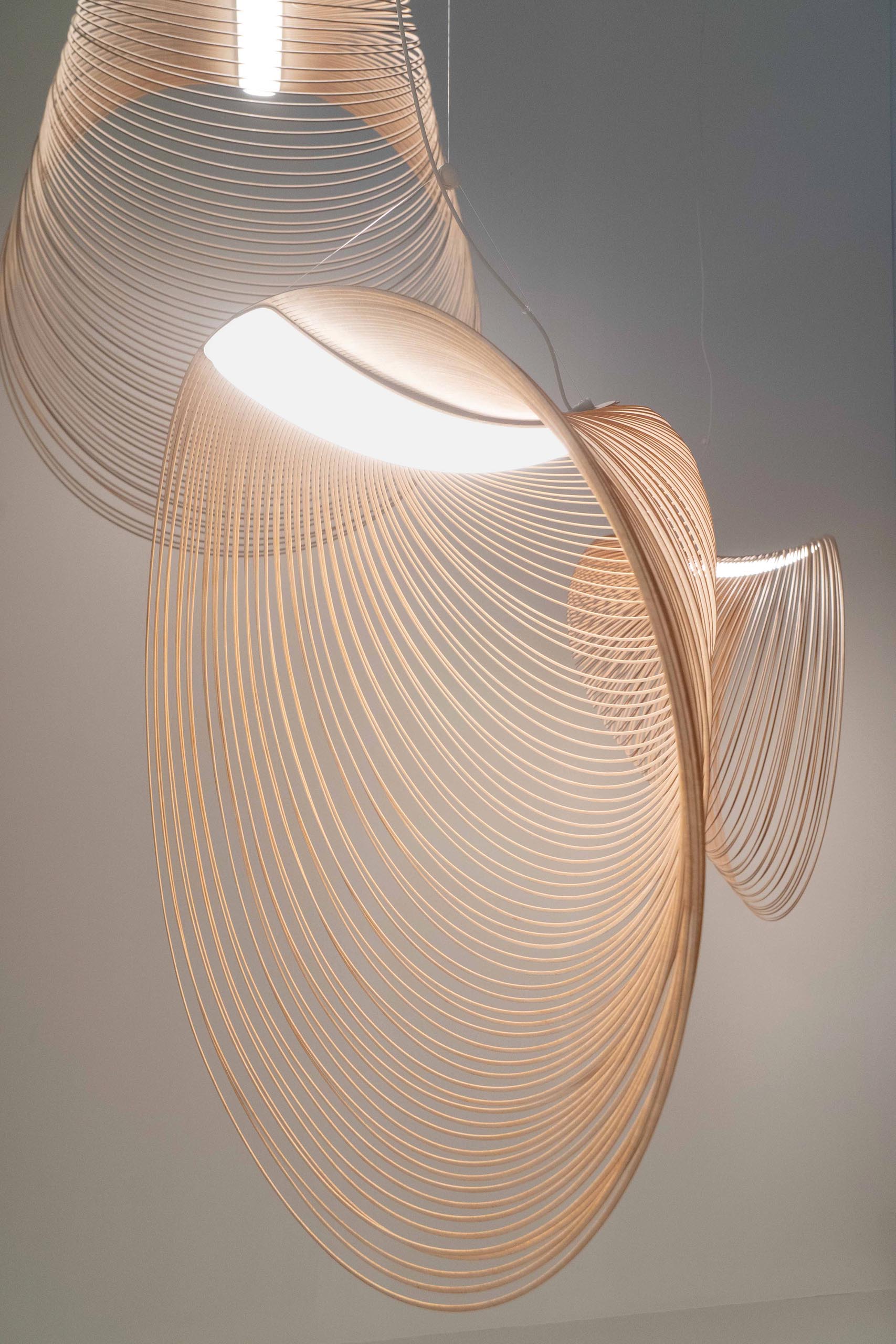 A sculptural pendant light made from laser cut wood and LEDs.