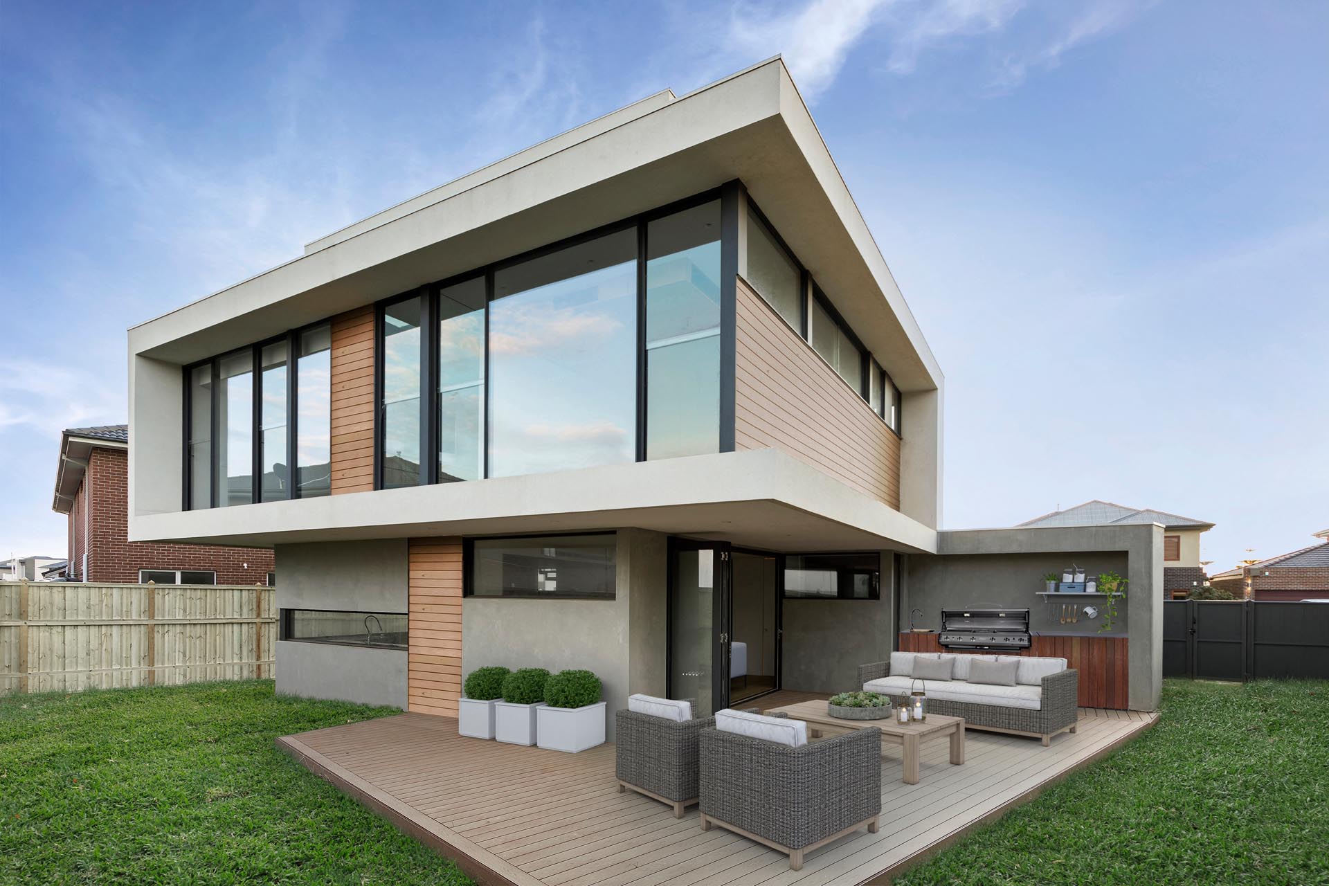 A modern house with a deck and outdoor kitchen.