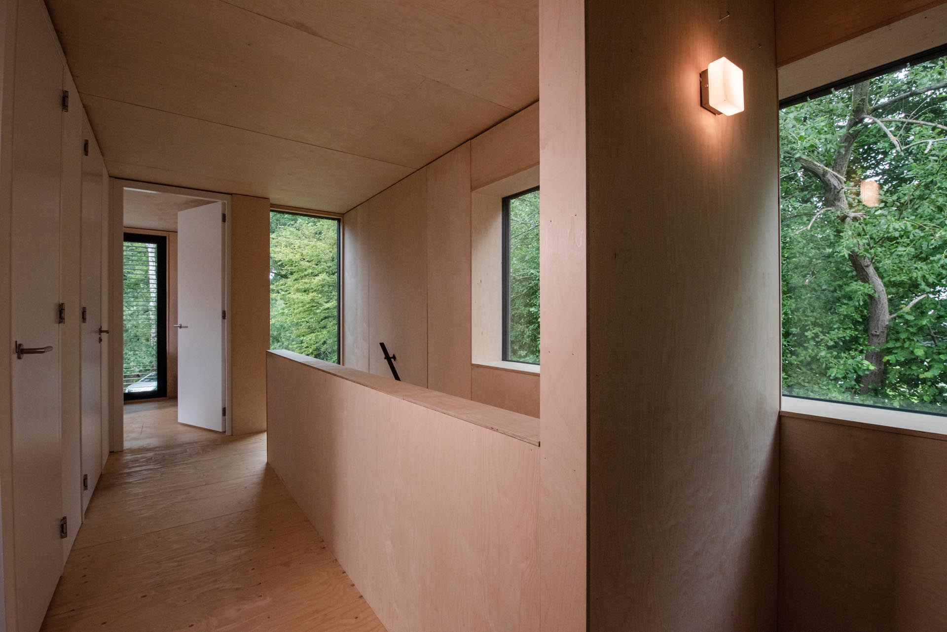 A modern home with a plywood interior and white doors.