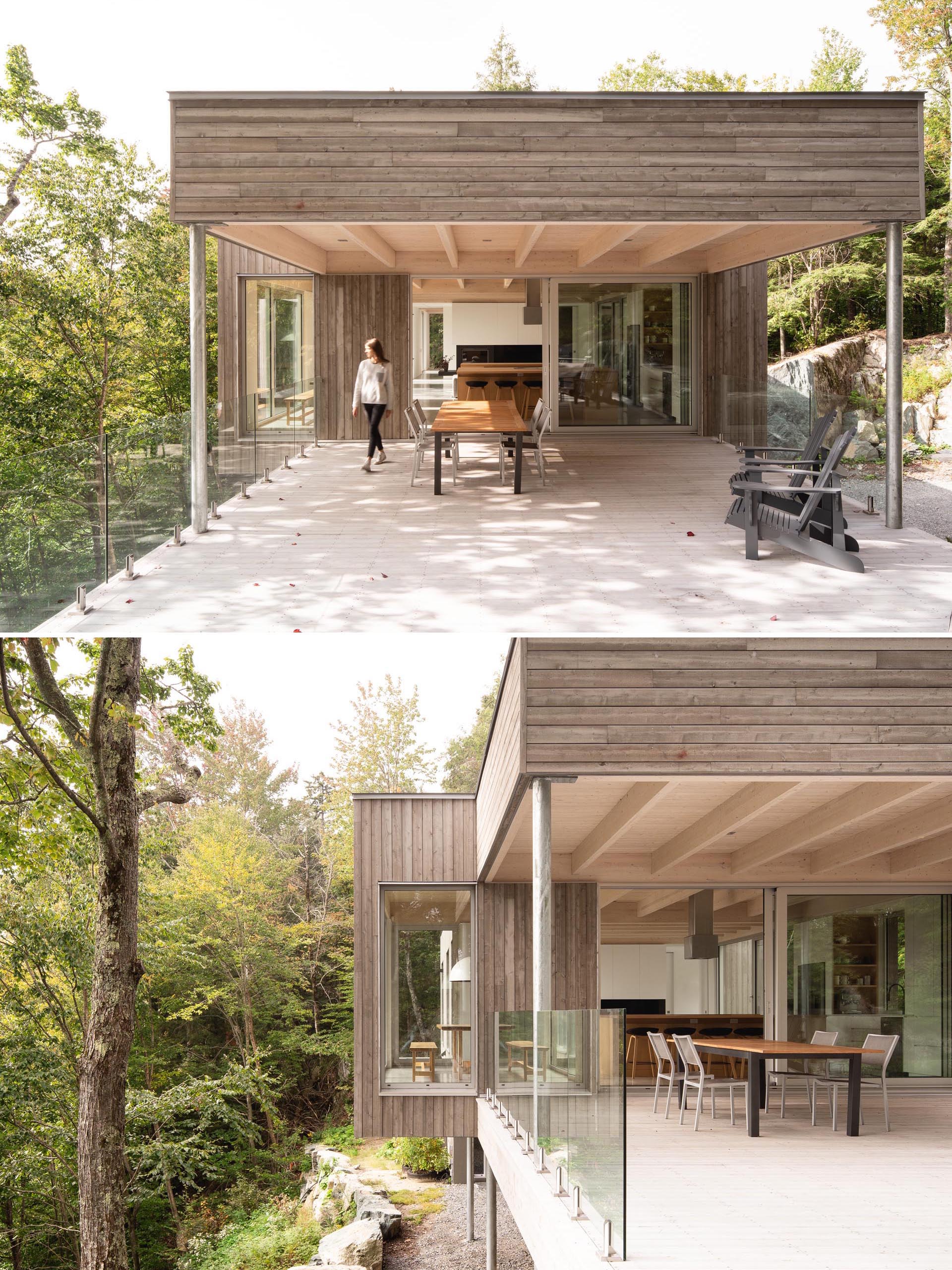 A large sliding door opens the interior spaces of this modern home to a partially covered terrace.