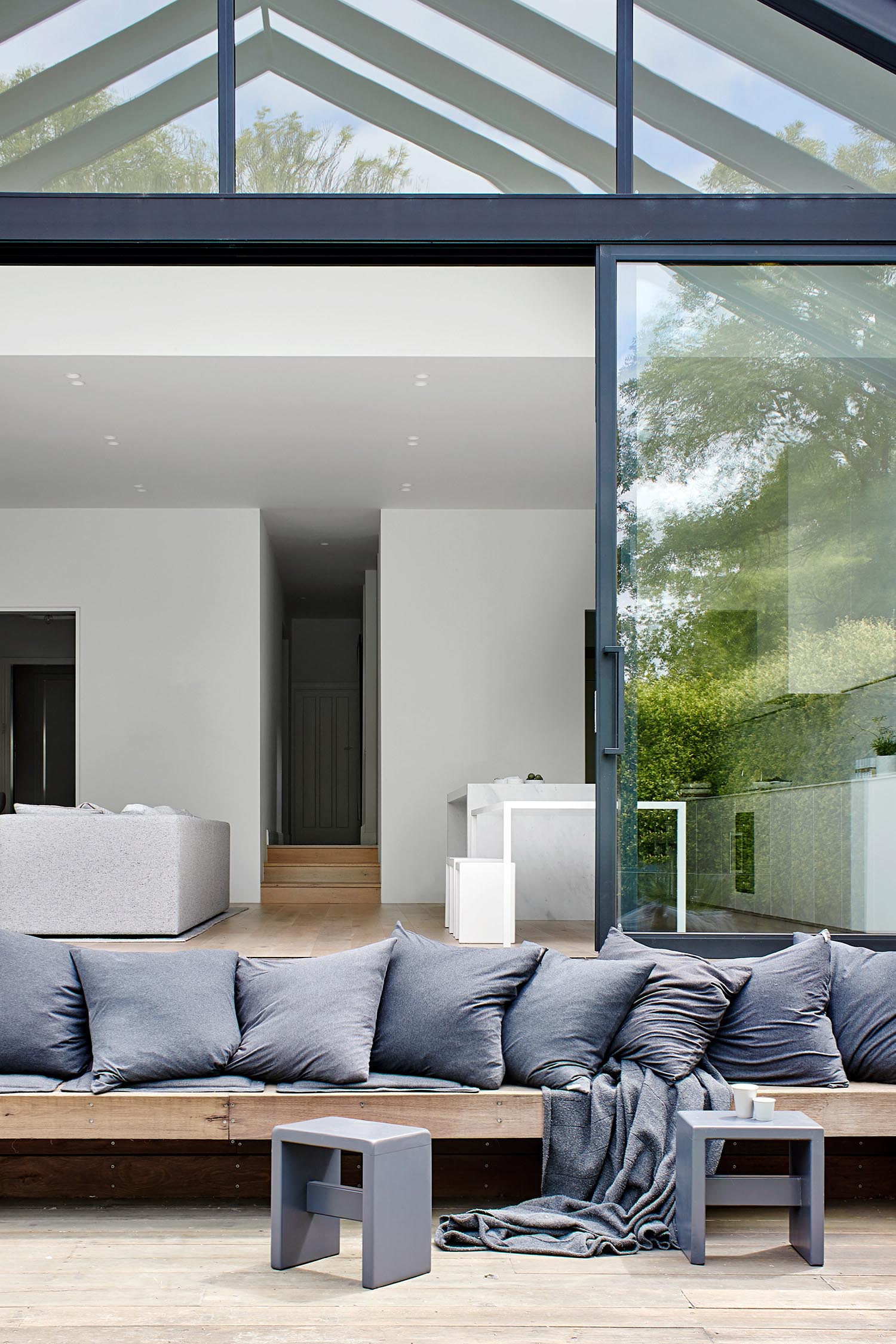 A modern house extension with a custom built outdoor seating area.