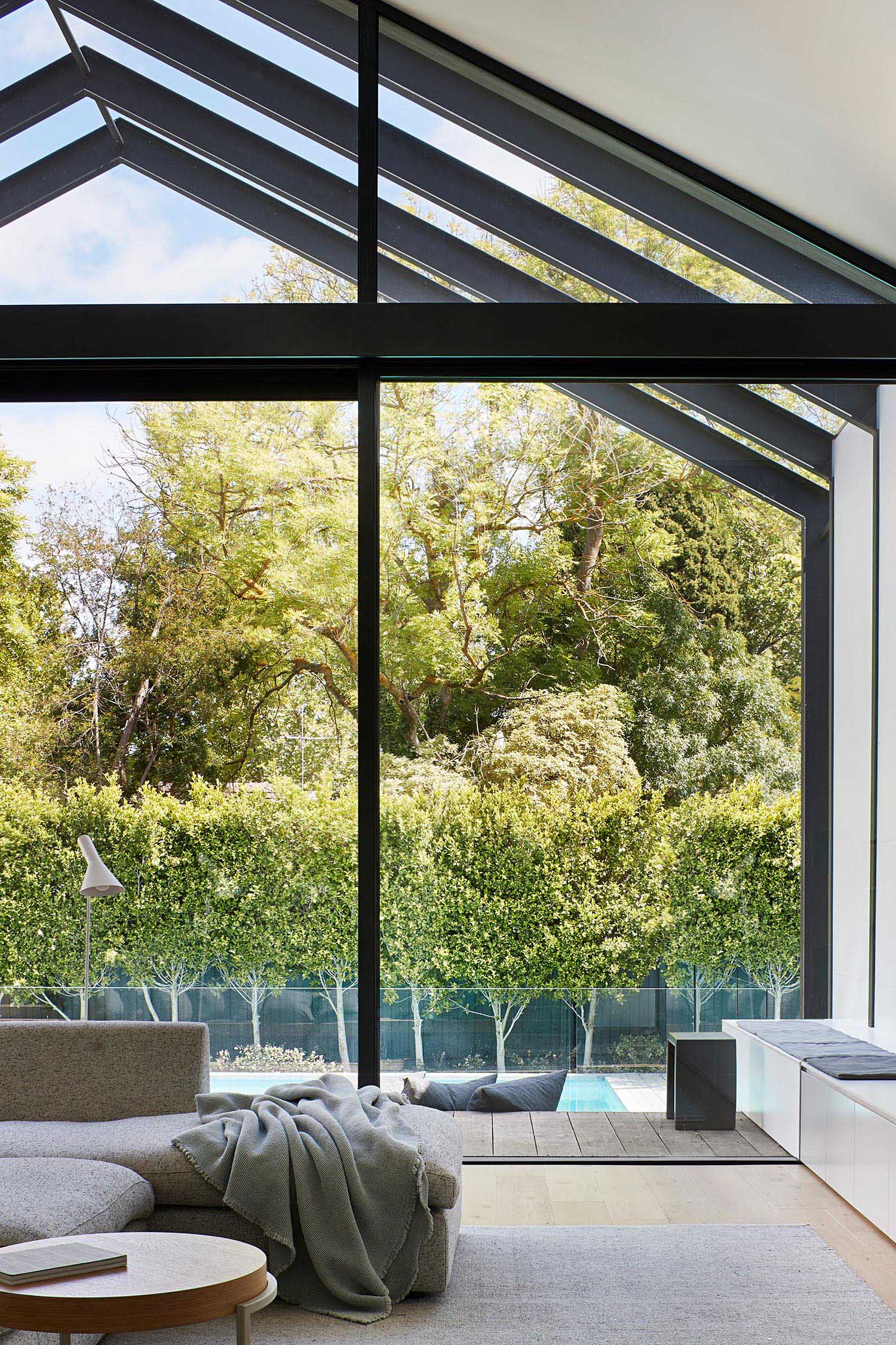 Black-framed glass doors and windows frame the backyard.