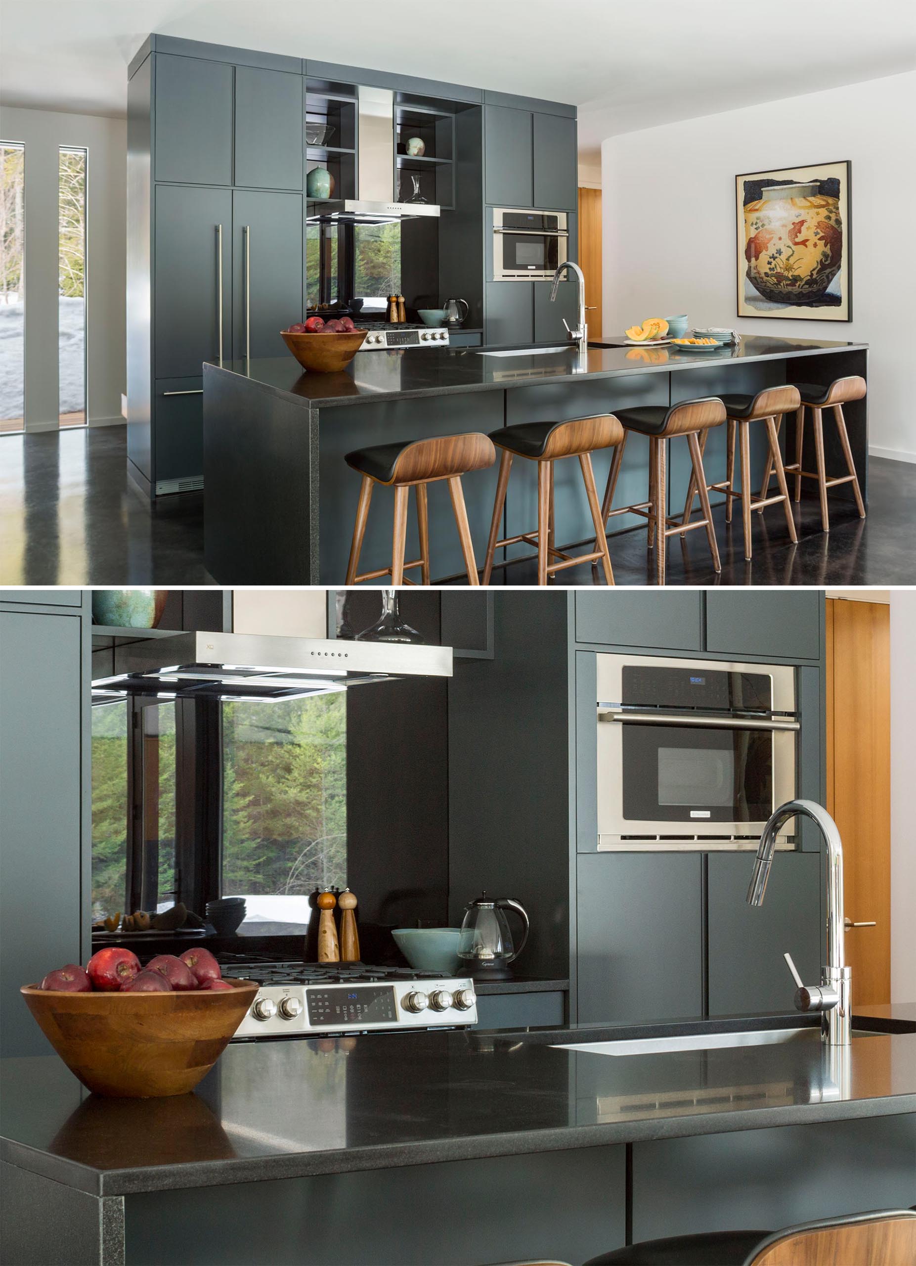 In this modern kitchen, dark gray cabinetry is paired with a dark countertop, while the stainless steel appliances and sink complement the cabinet hardware.