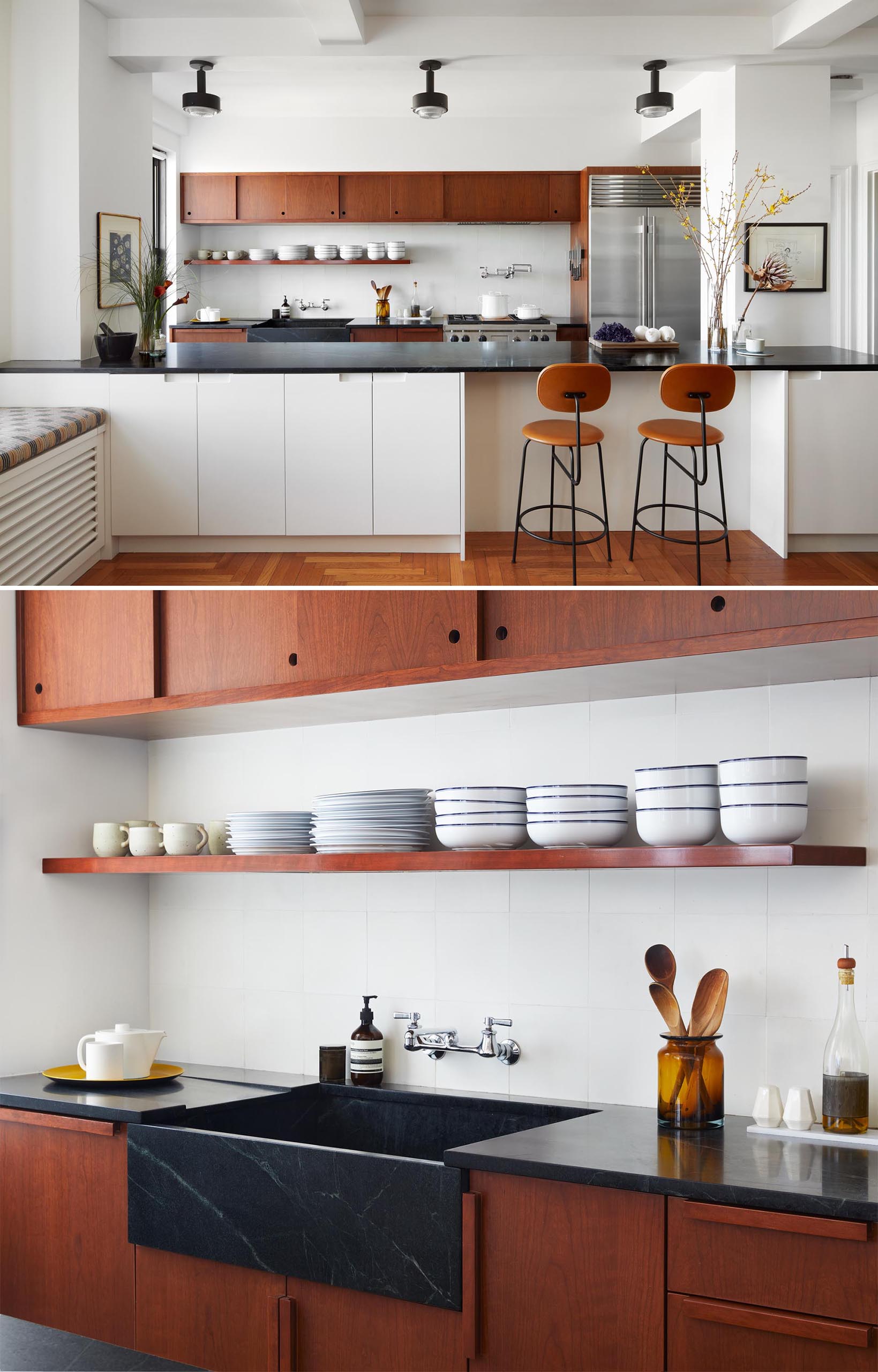 A remodeled kitchen with custom auburn cherry cabinetry inspired by mid-century Southern California woodwork, and has integrated handles and sliding doors, and a black soapstone countertop.