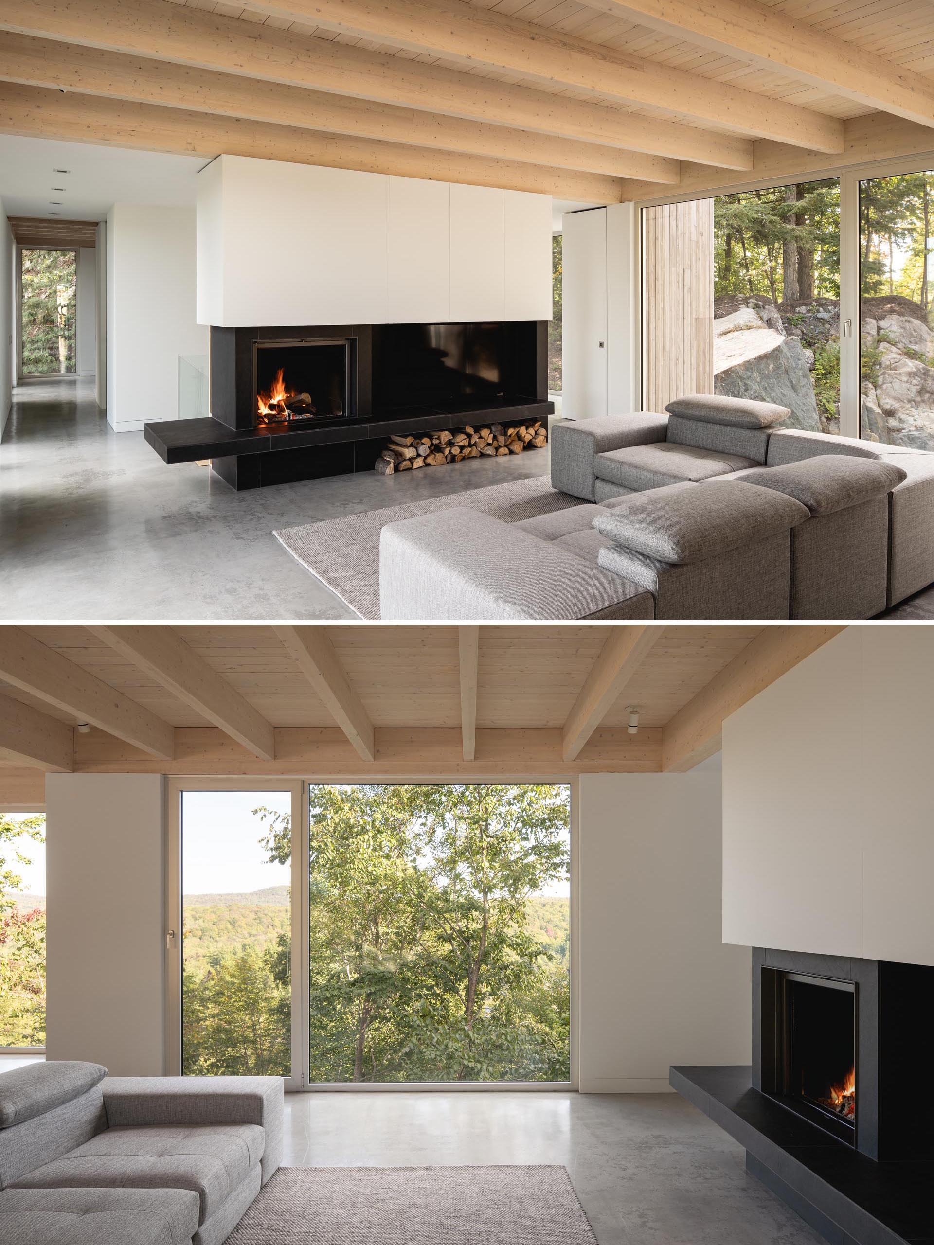 A black fireplace surround that incorporates the television adds a contrasting element, and the exposed roof structure is made from black spruce.