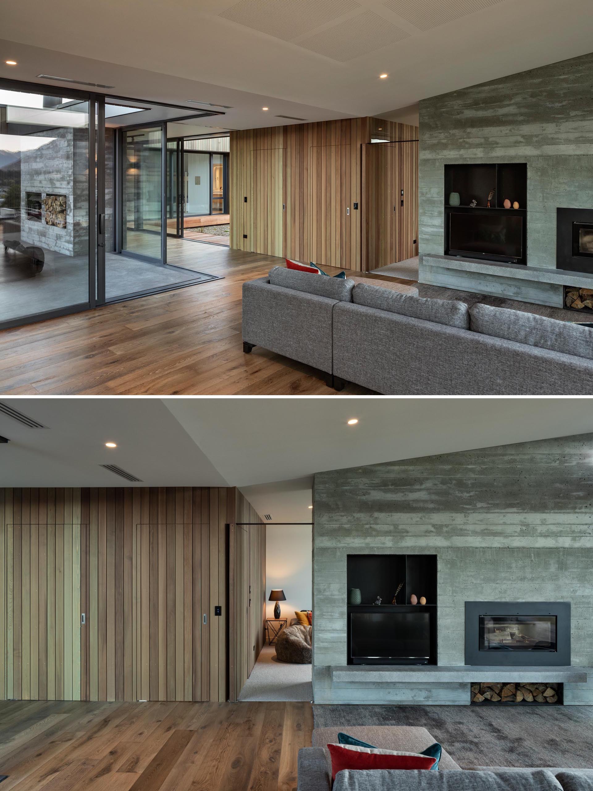 A modern home with a board-formed concrete fireplace in the living room that matches an outdoor fireplace in the courtyard.