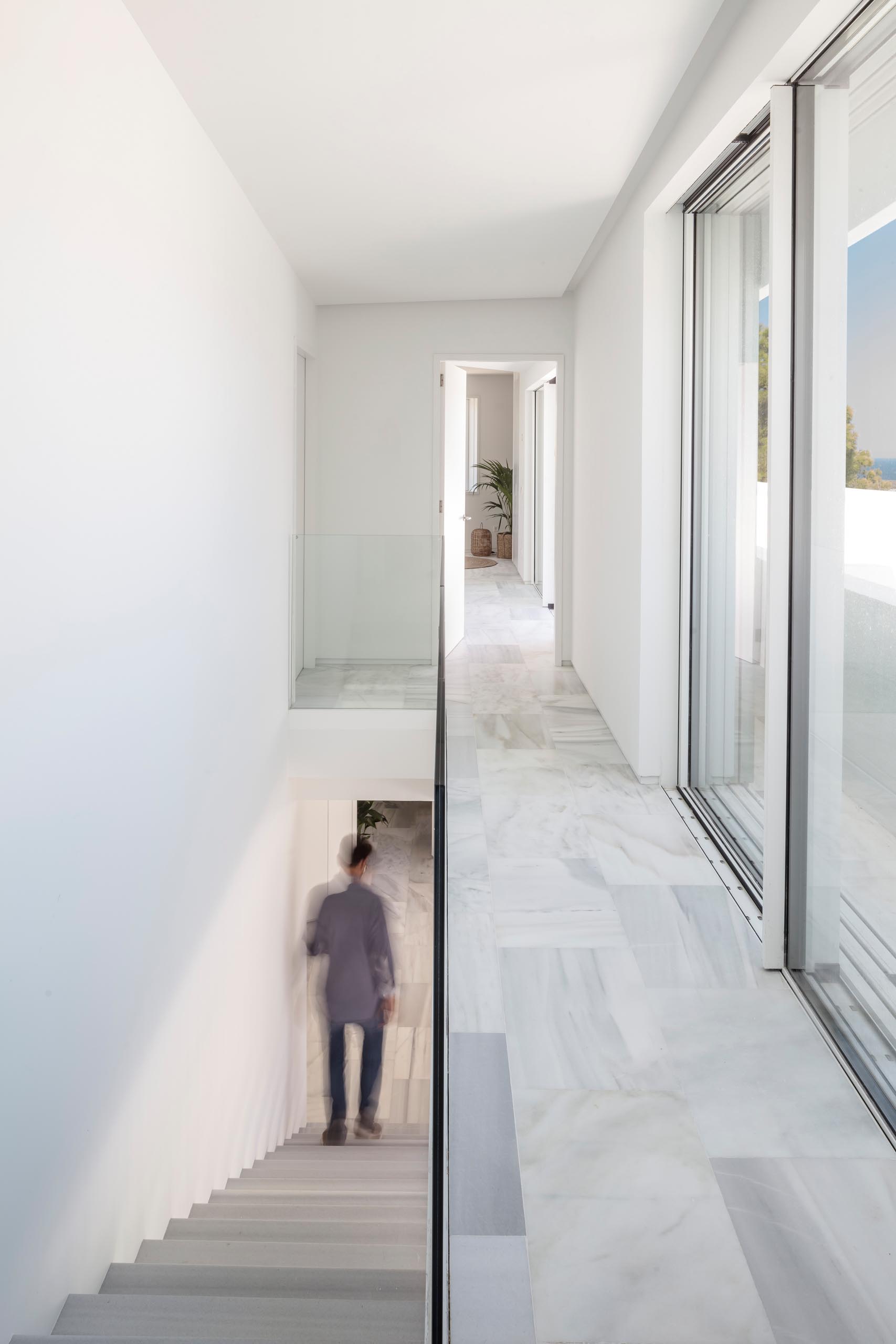 A modern house with an open hallway that overlooks the stairs.