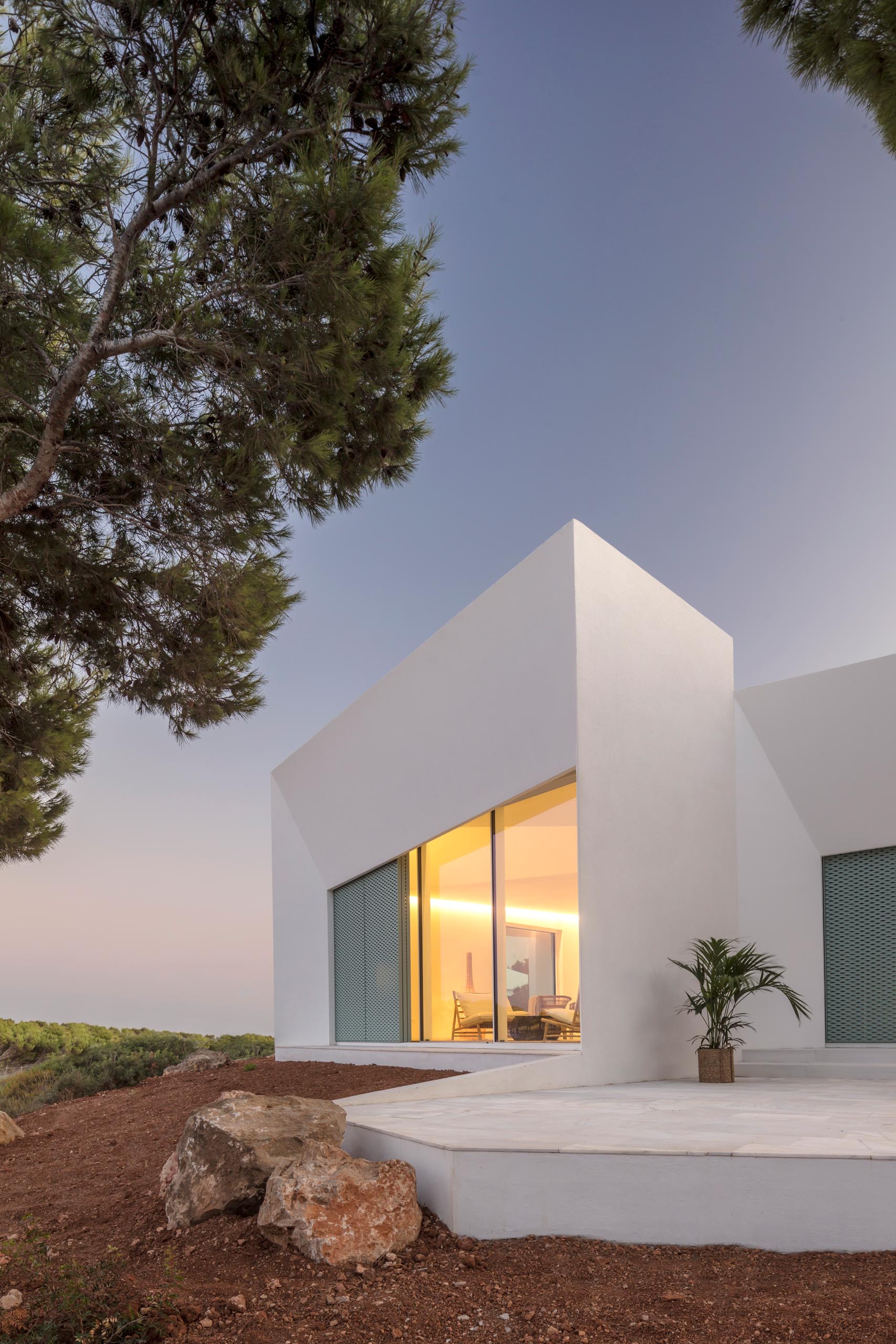 The Modern White Minimalist  Exterior  Of This Home  Is Softened By The Pastel Design Elements 