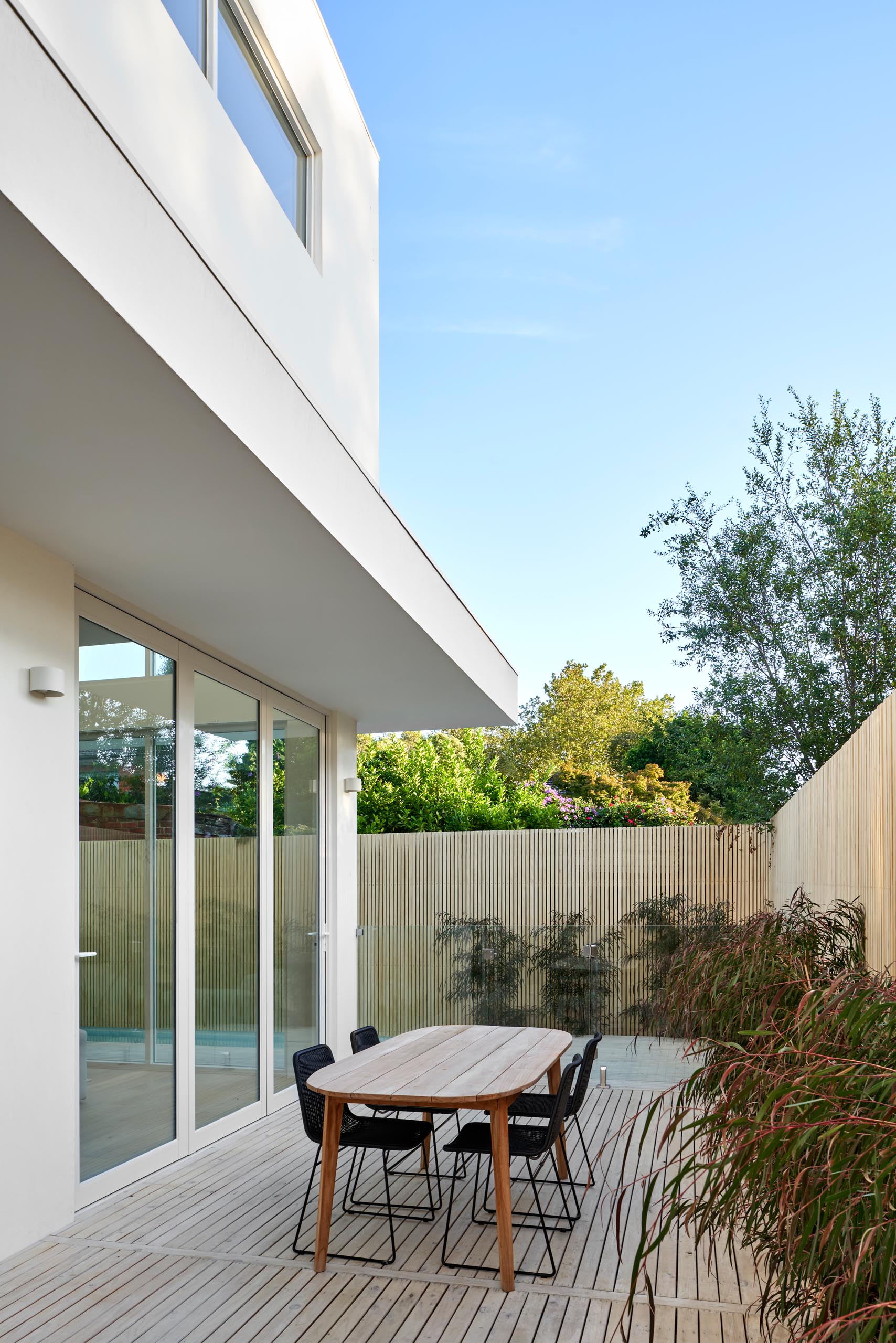A modern house with a patio for outdoor dining.