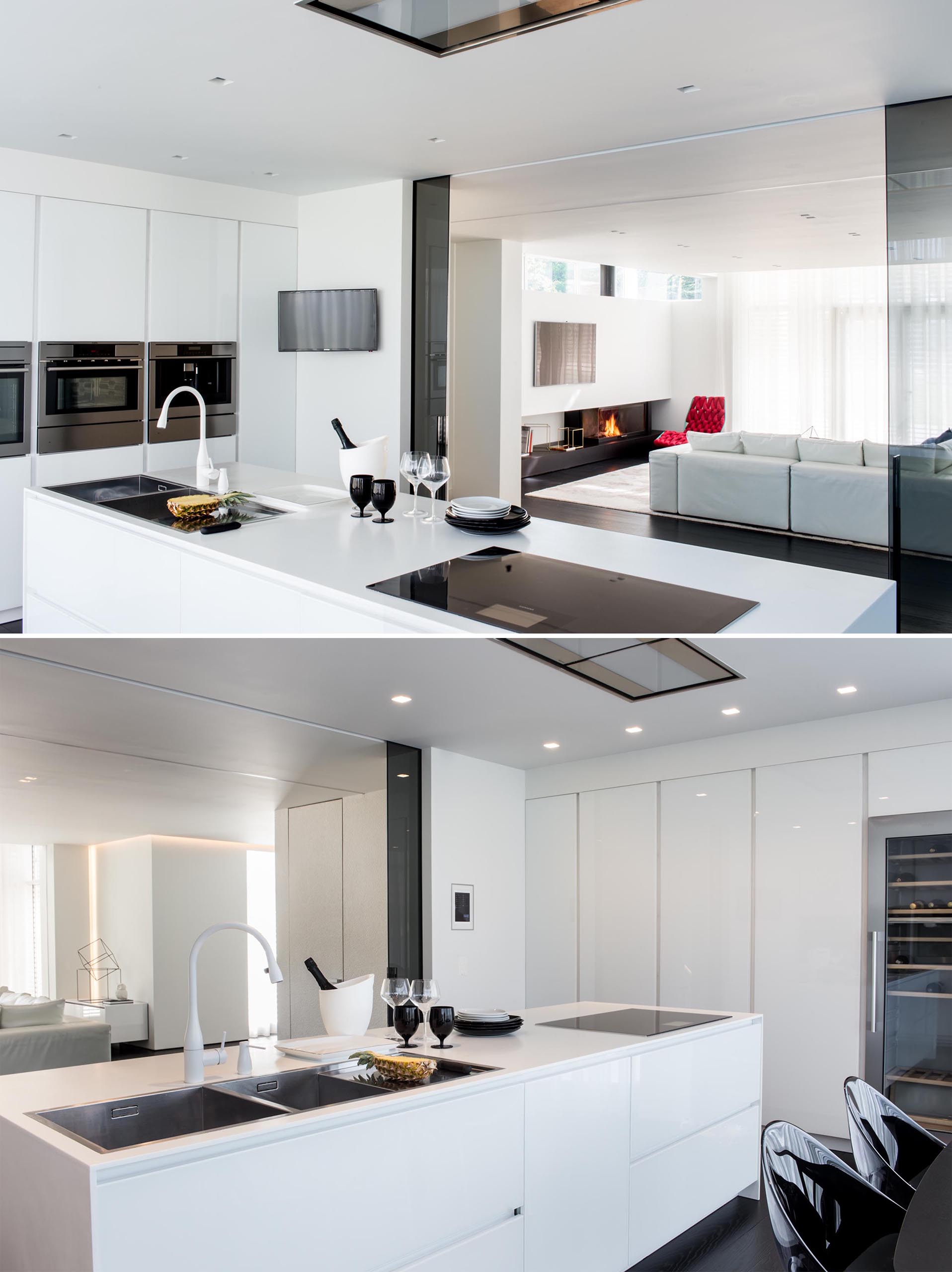 A modern kitchen with minimalist white cabinets, stainless steel appliances, and an island.