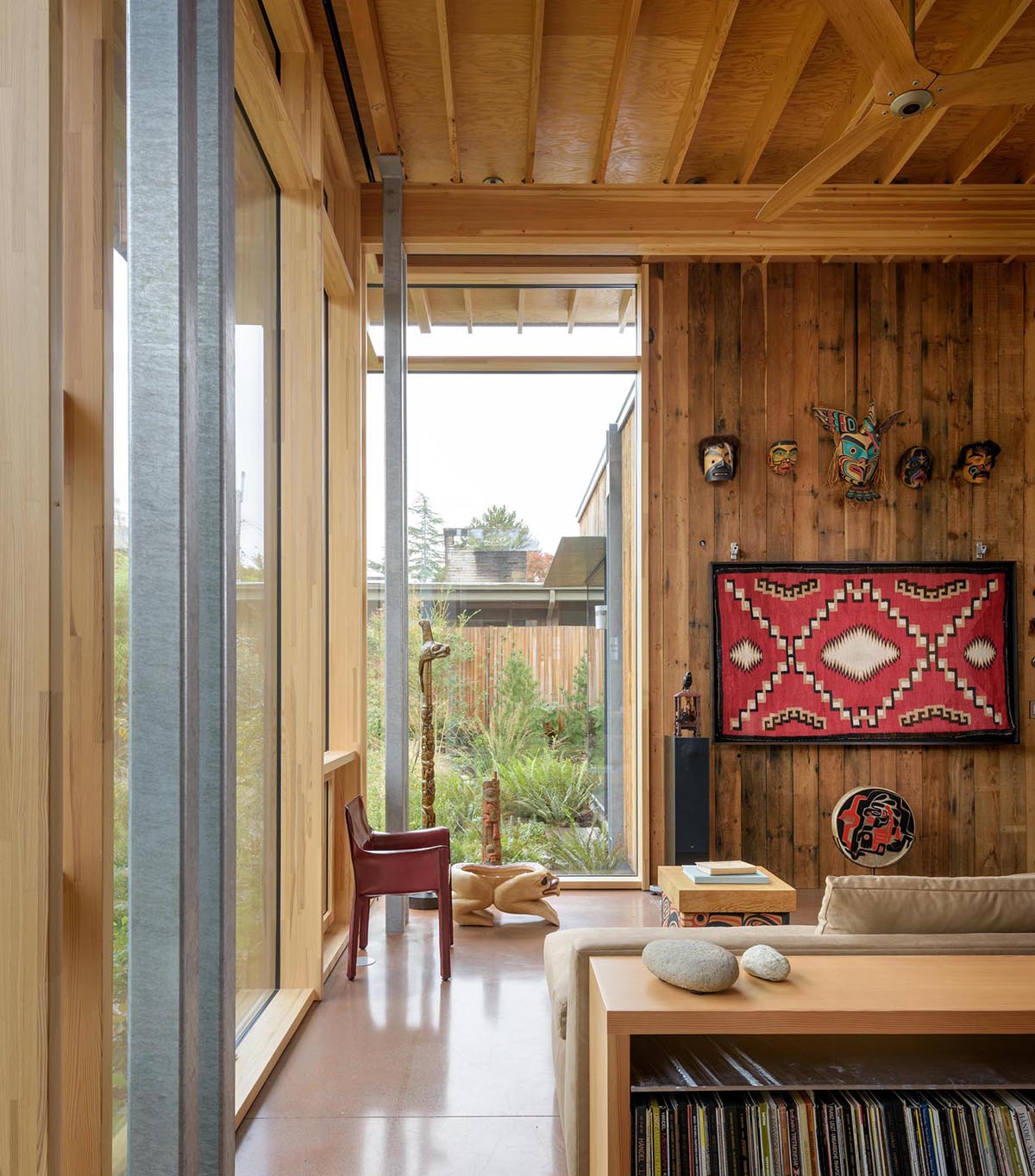 A cabin with large windows that look out to the garden.