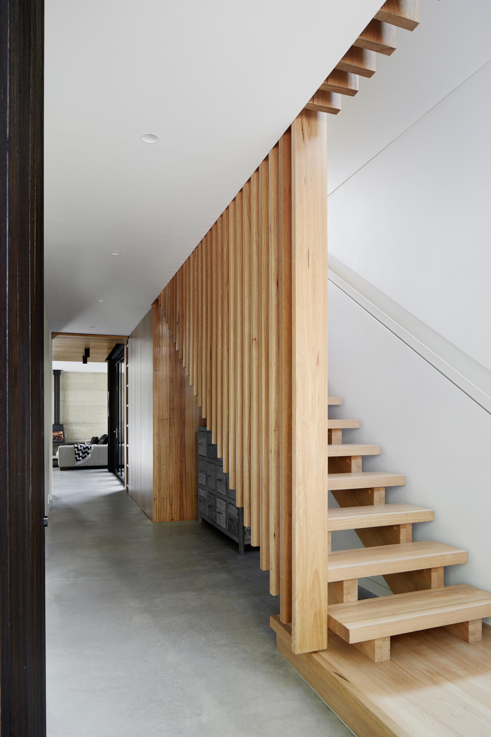 Modern wood stairs with a built-in handrail with lighting.