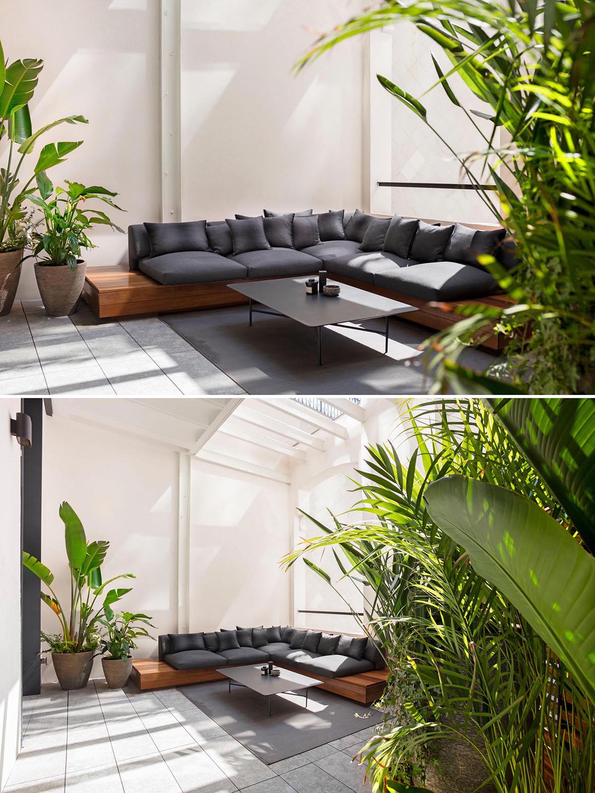 A modern sunroom with an L-shaped sofa and potted plants.