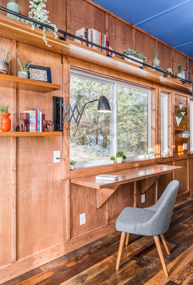 This tiny home has a solid maple fold out desk that takes advantage of the natural light coming in through the window.