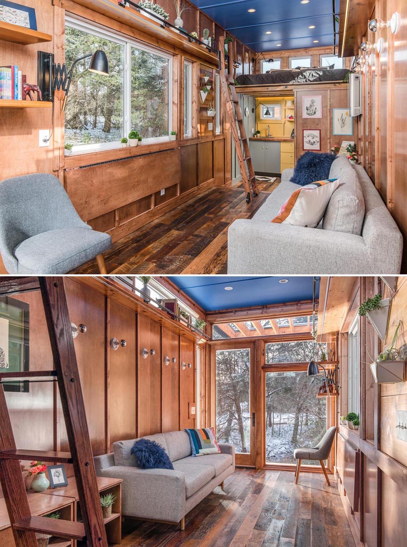 Stepping inside this tiny house, the open space is dedicated to the living room, where you'll find reclaimed hardwood floors and maple siding with maple batten strips.