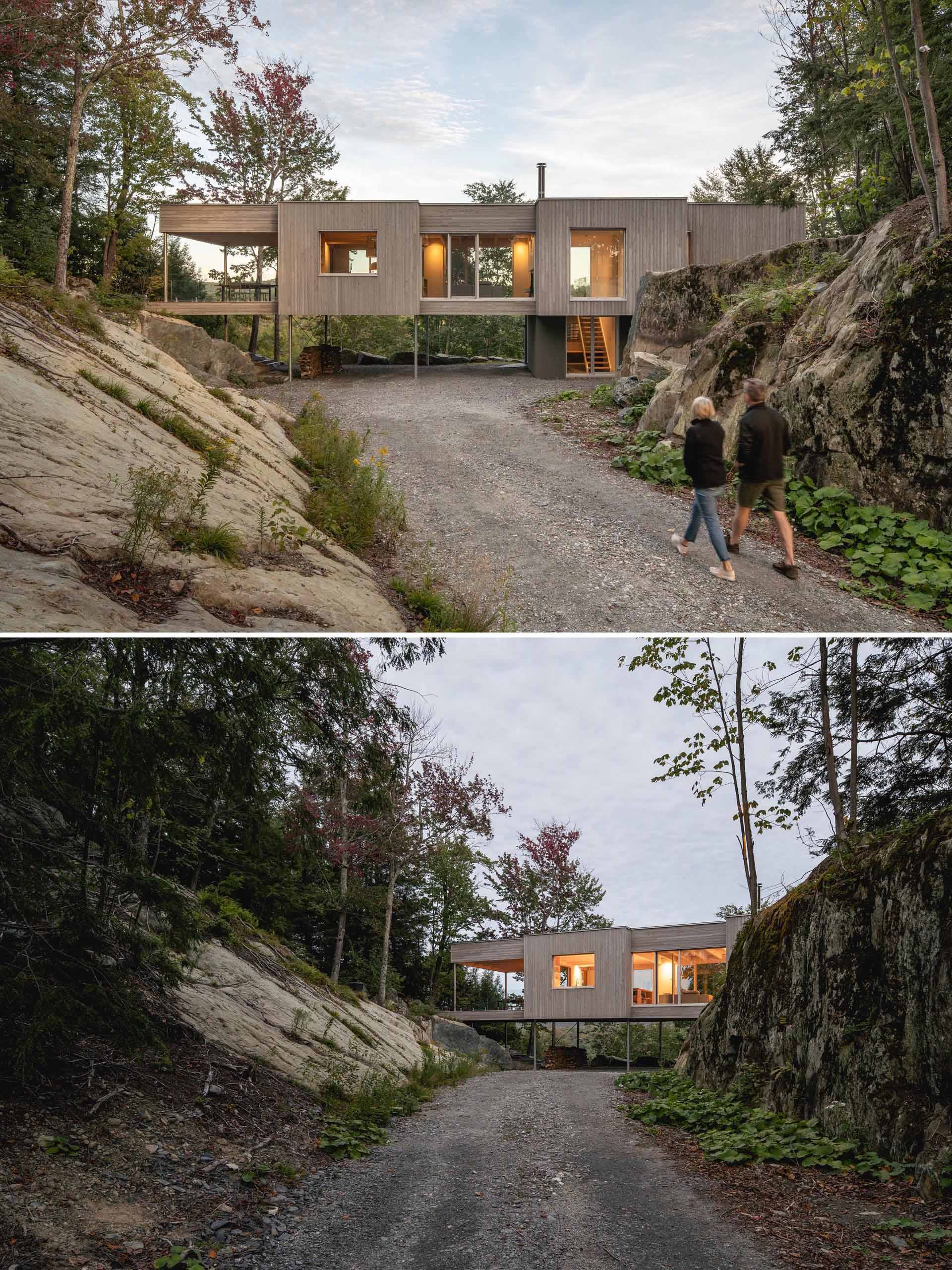 This modern house in the forest is clad in eastern white cedar, which was pretreated with a product that accelerates the greying process