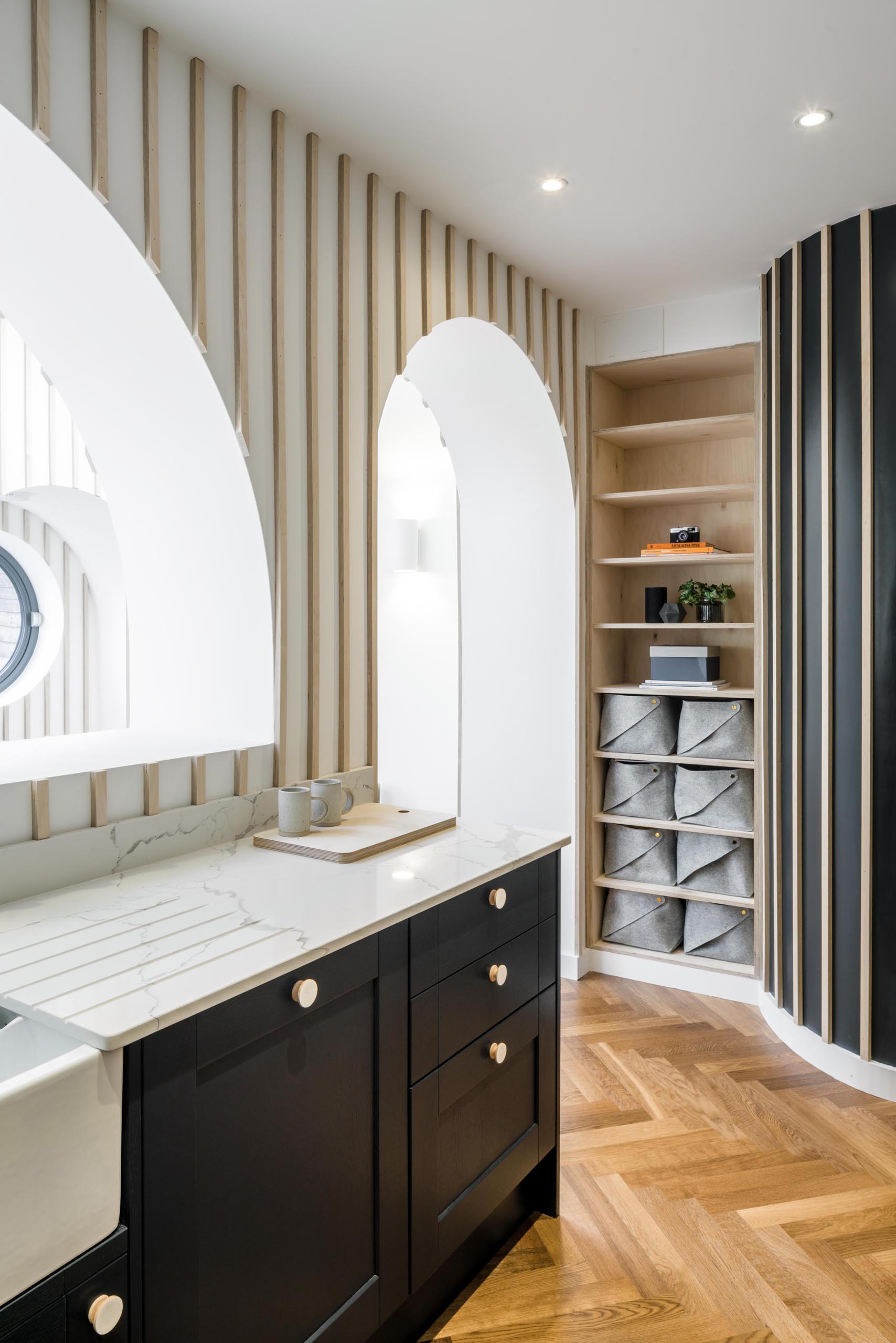 A modern interior with vertical wood accents and built-in shelves.