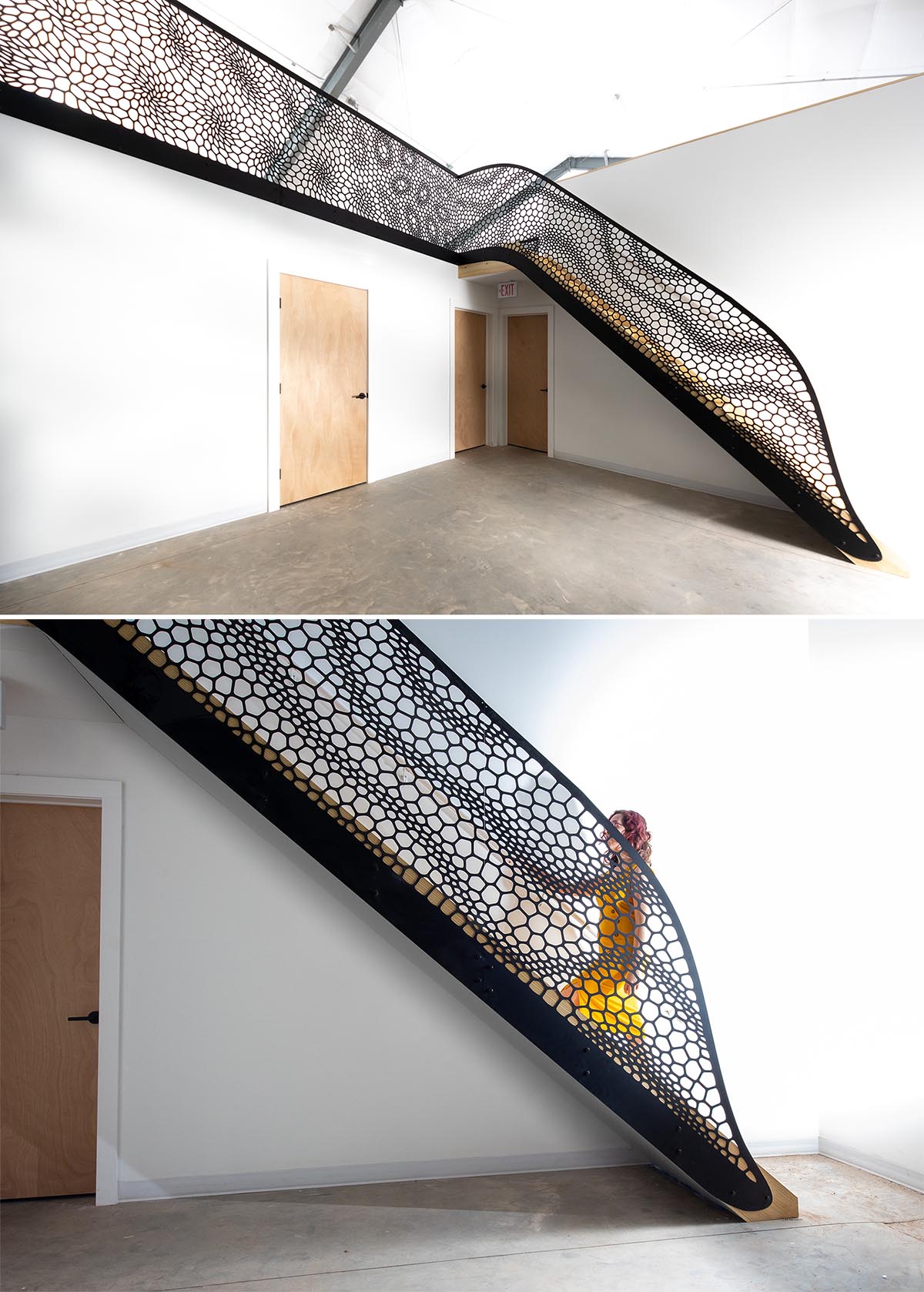 An artistic laser cut staircase railing with a matte black finish.