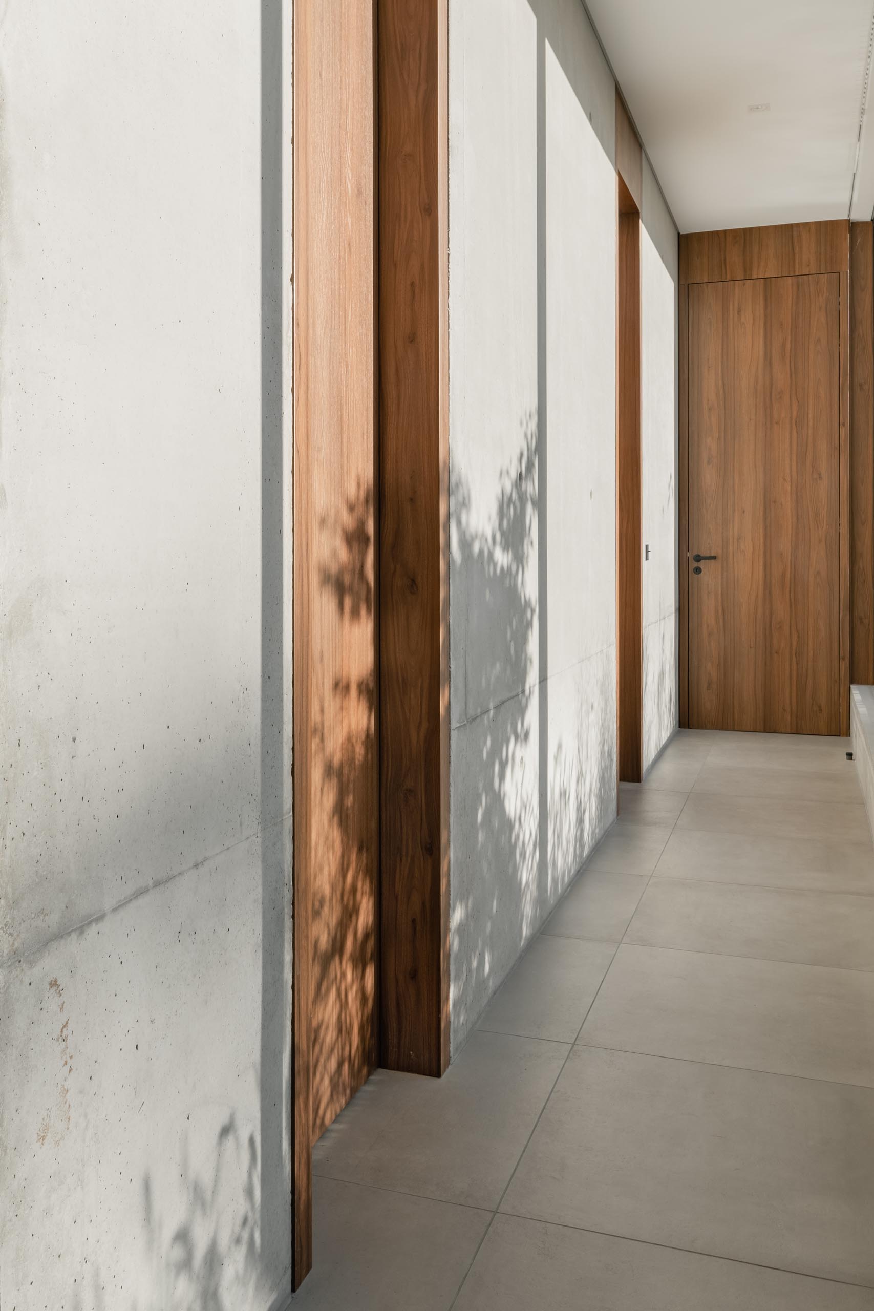 Floor-to-ceiling windows line this modern hallway and add plenty of natural light.