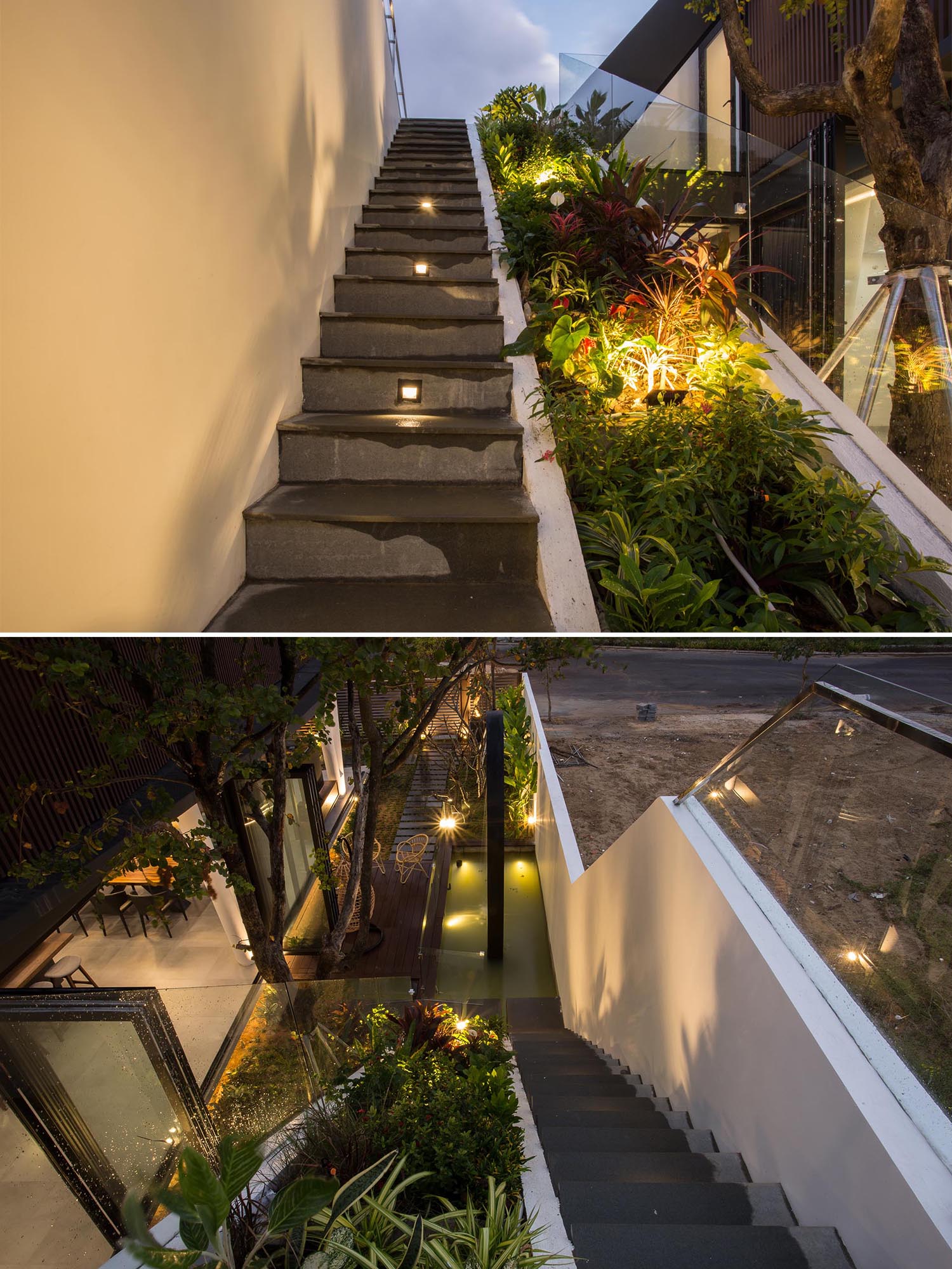 A modern home with exterior stairs that run alongside a heavily planted sloped section and a glass railing.