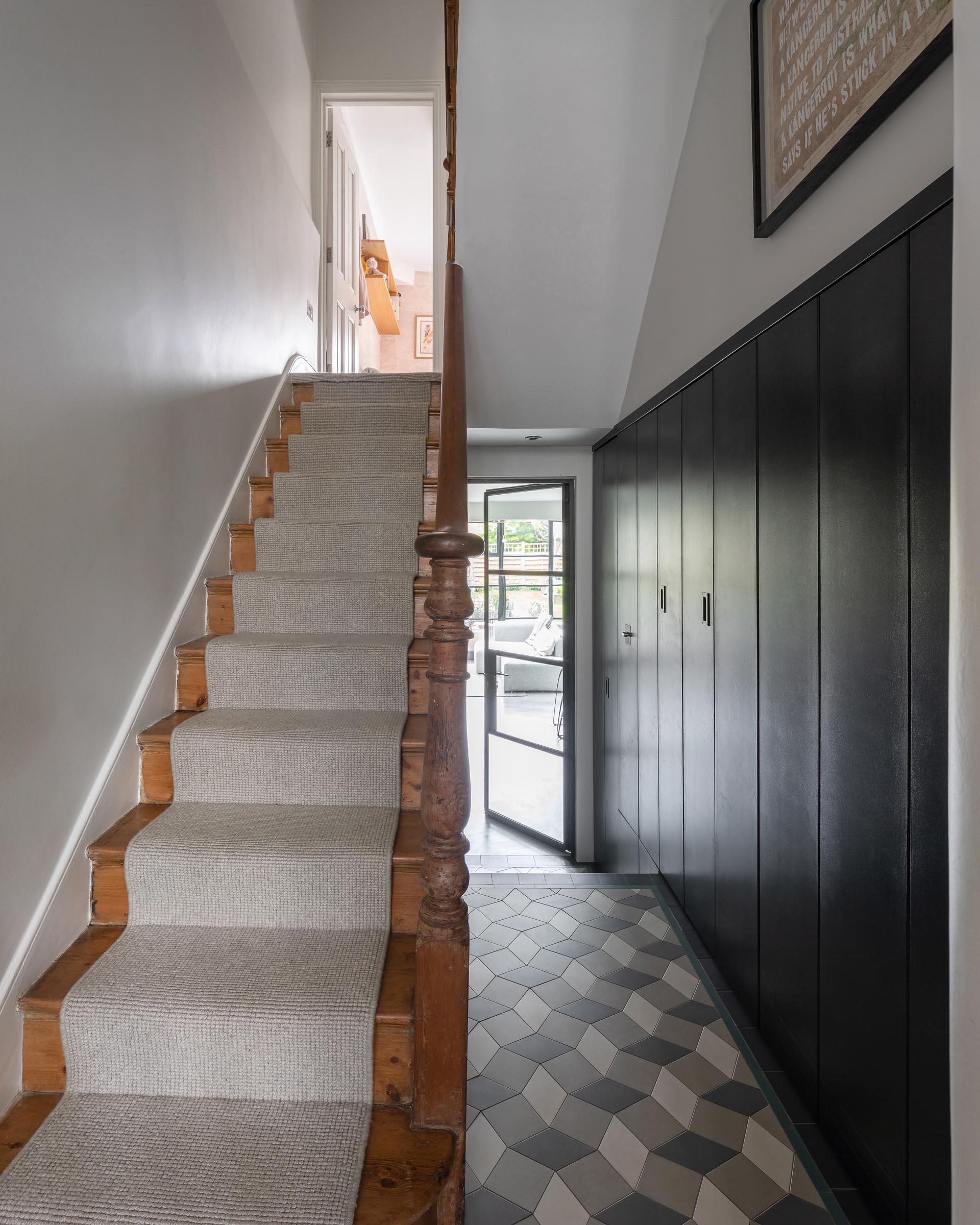 A hallway and staircase connect the original home to a new addition.