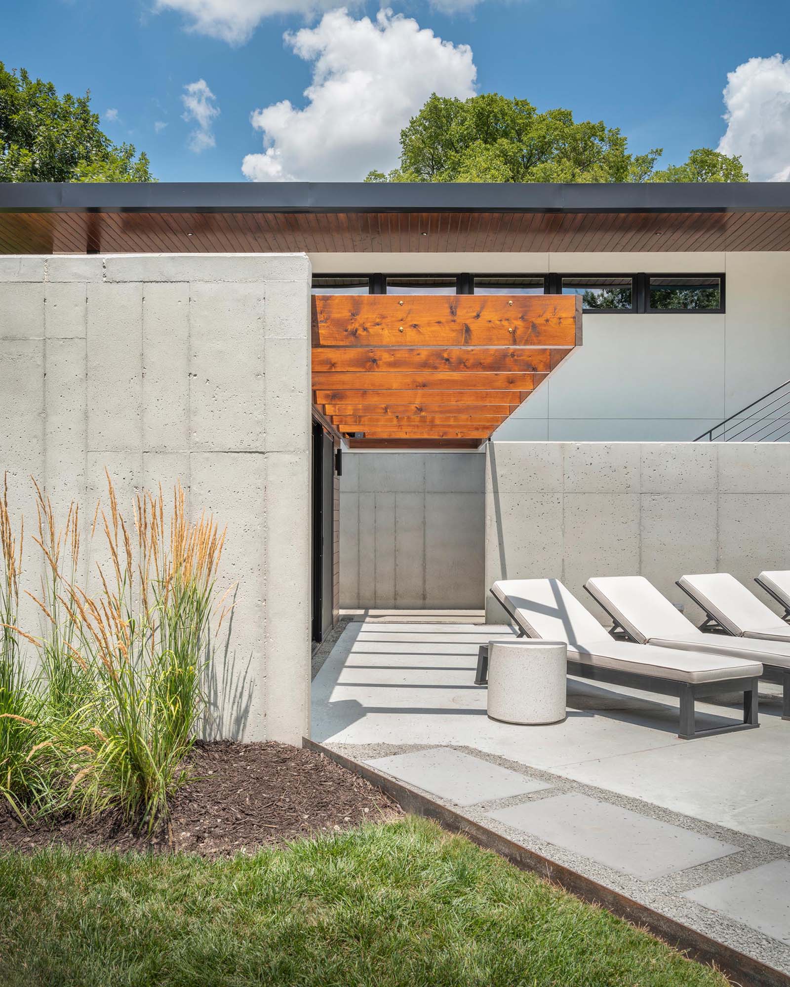 A home with exposed concrete that's accented by stained cedar.