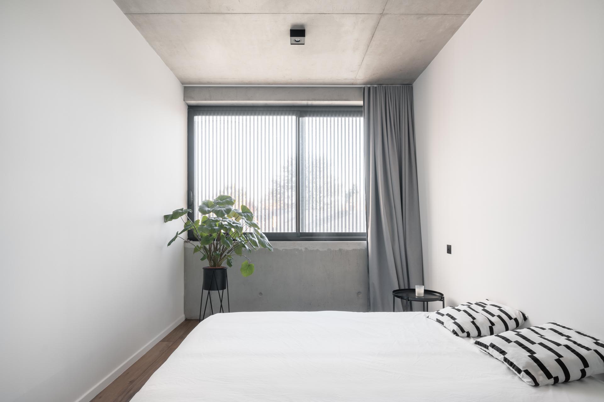 A modern bedroom with minimalist furnishings.