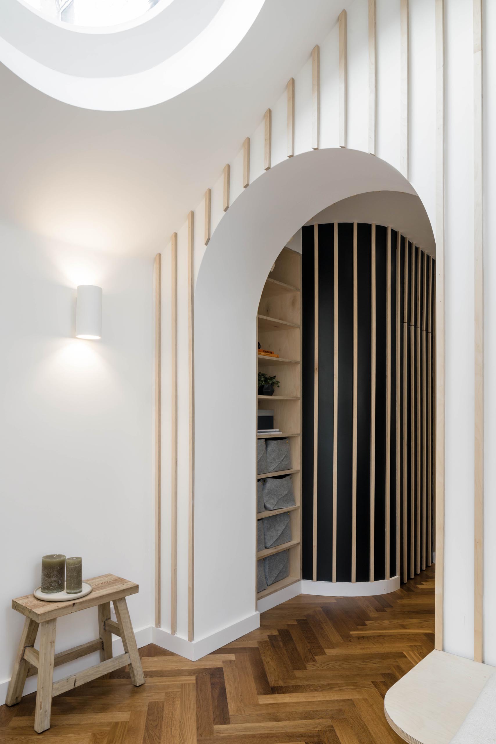 A modern interior with vertical wood accents and built-in shelves.