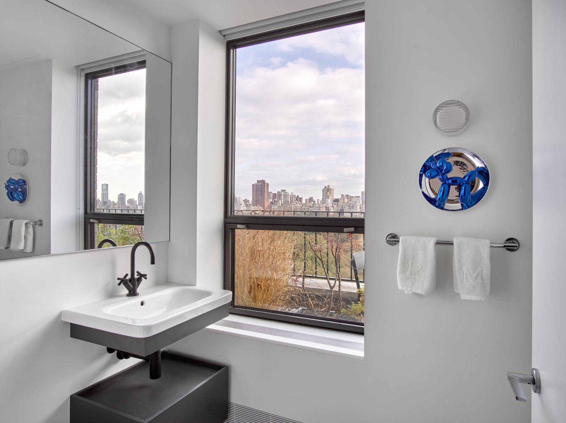 A simple bathroom with a gray and white vanity.