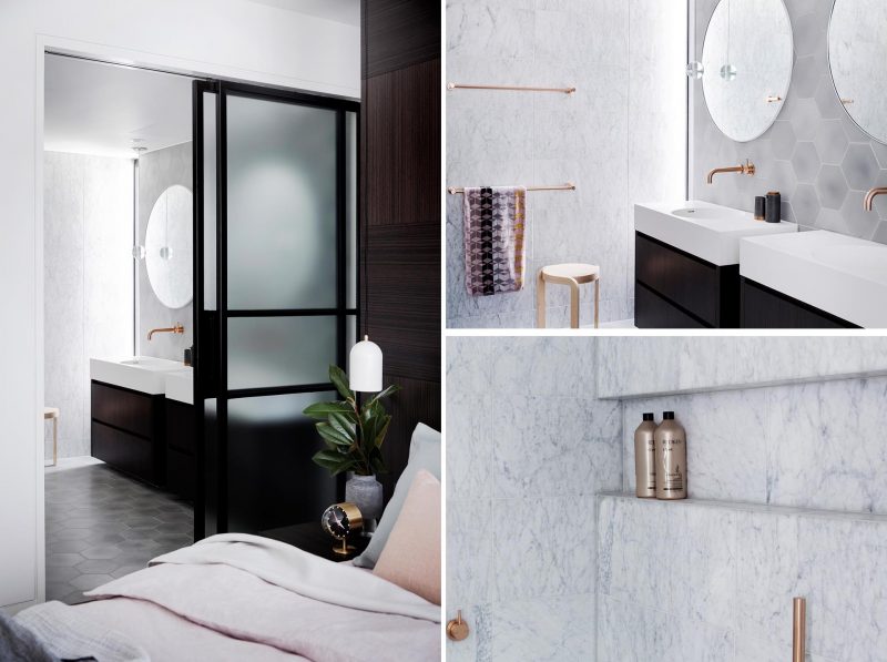 A modern master bathroom with marble walls, dual vanities, and hexagonal gray tiles.