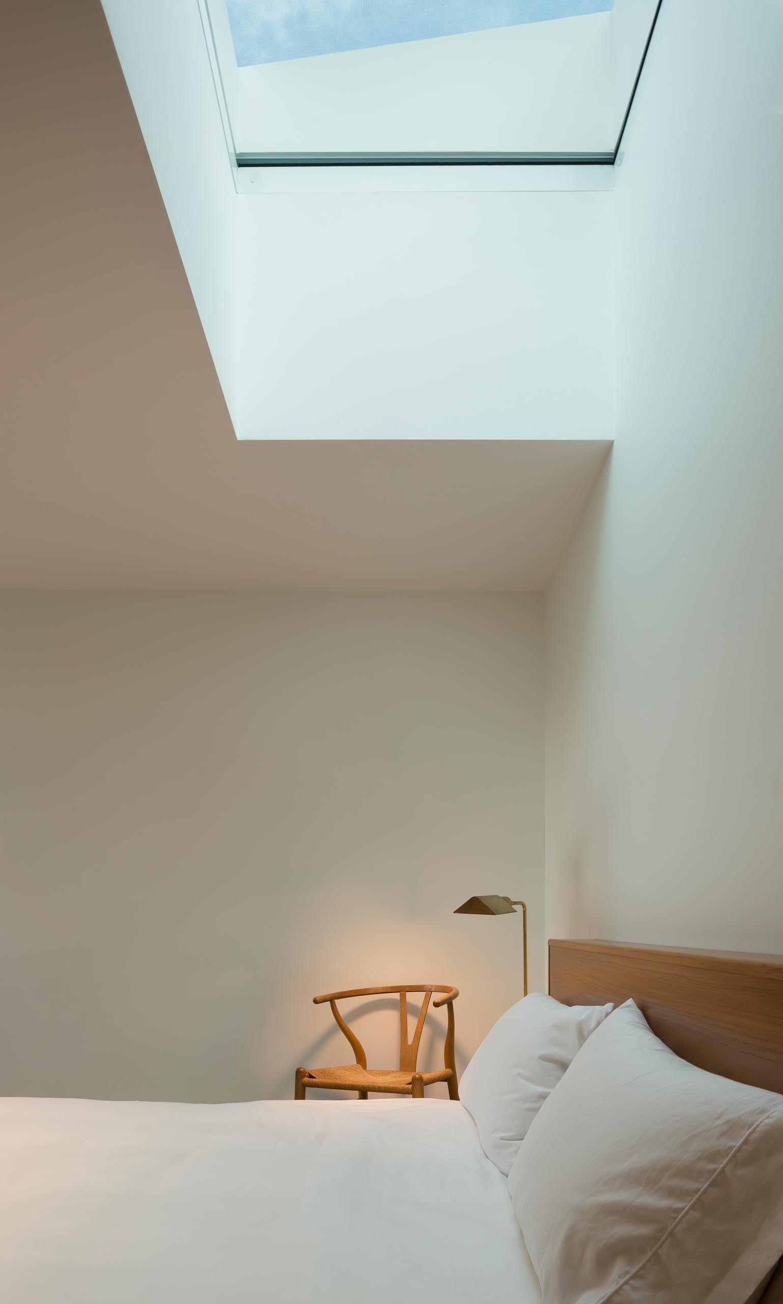 A modern bedroom with a skylight.