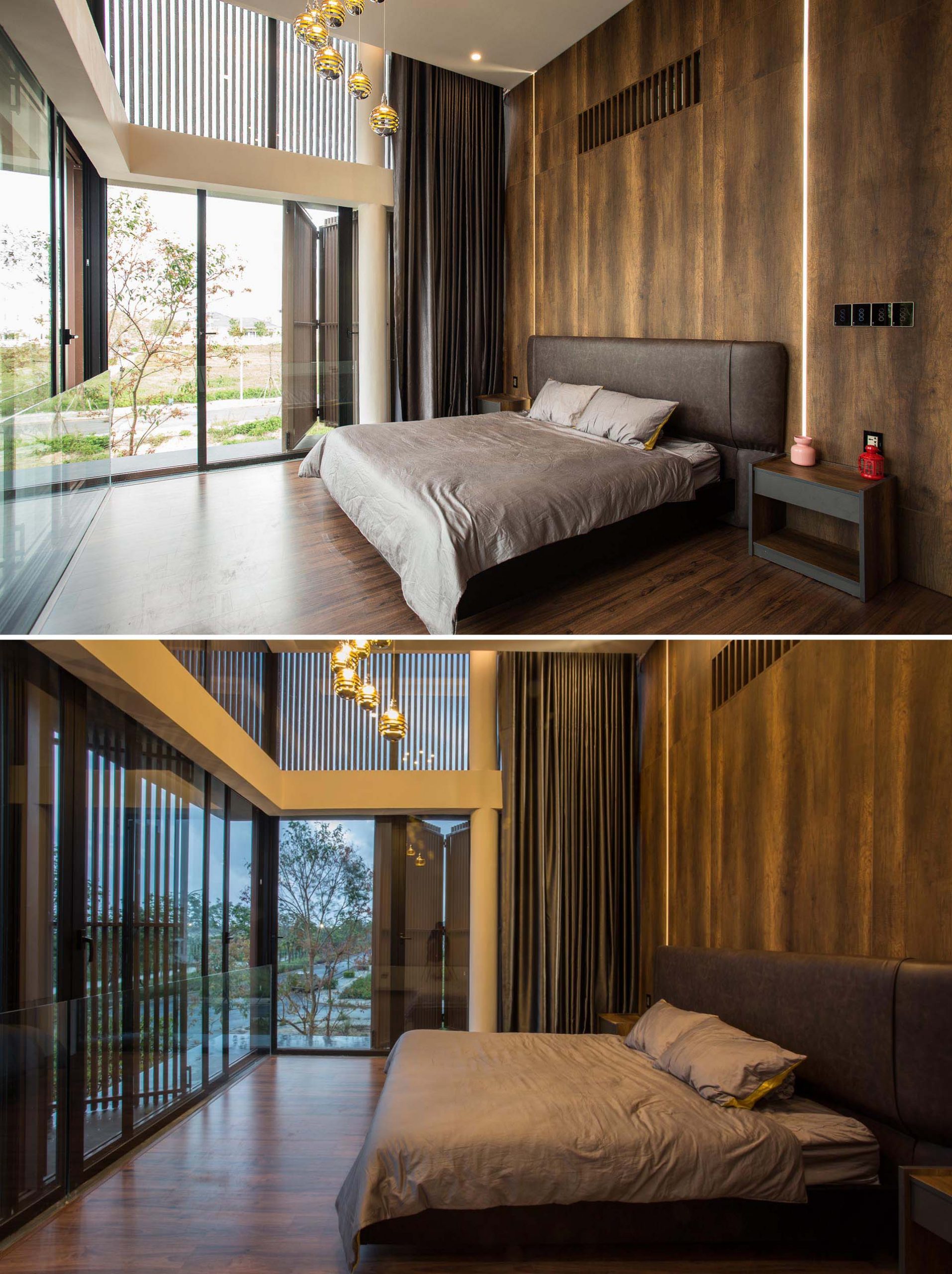 In a modern bedroom, the high ceiling allows for a grand appearance, while a wood accent wall has strips of LED lights that run from the ceiling to the floor.