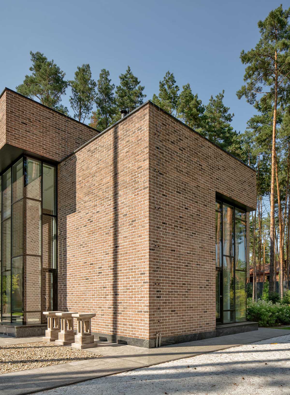 A modern brick home with black window frames.