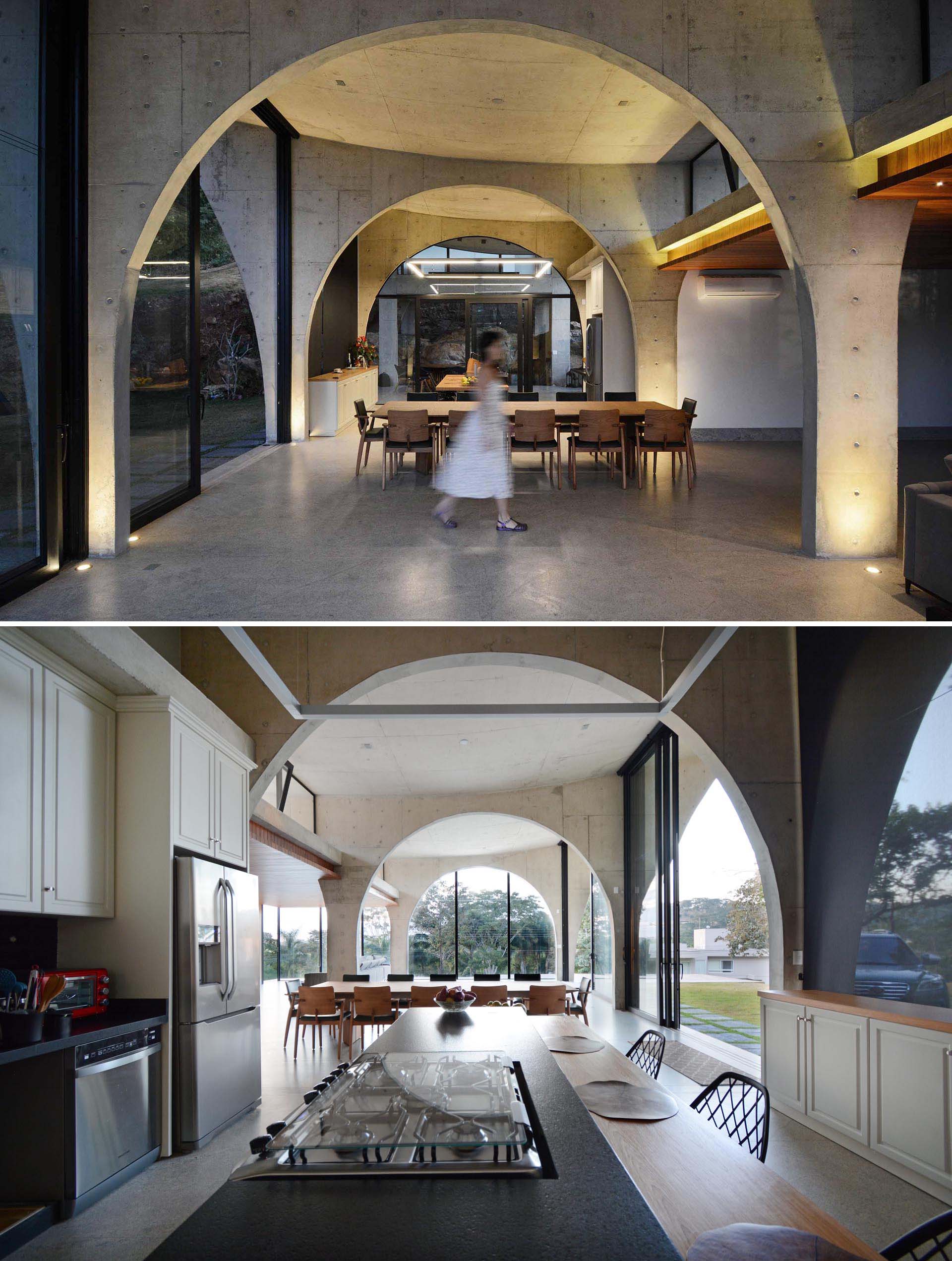 Concrete arches are key in creating an sense of space and height throughout this modern home.