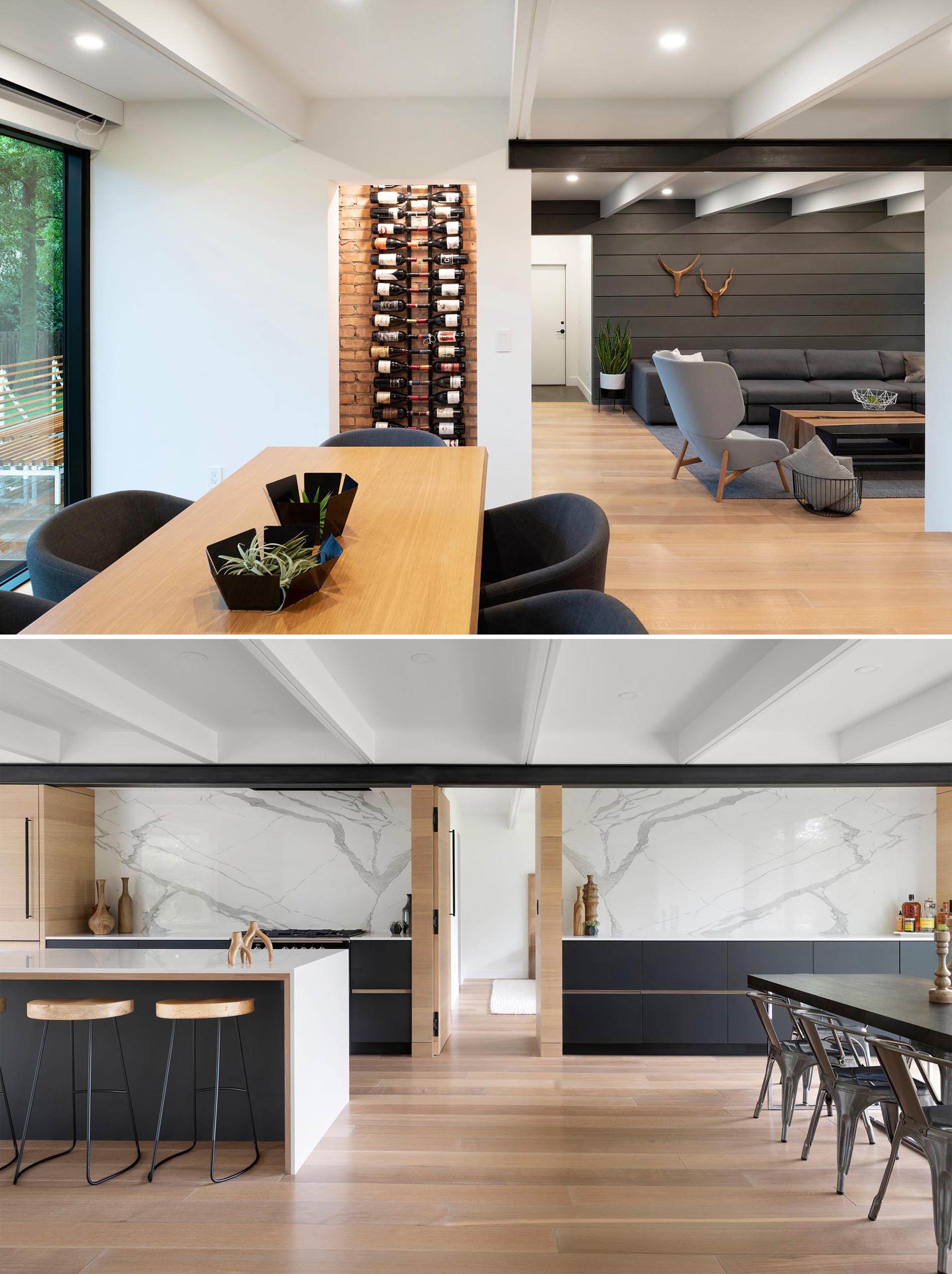 A wood dining table with dark gray chairs are complemented by a black wine rack that highlights a brick wall.