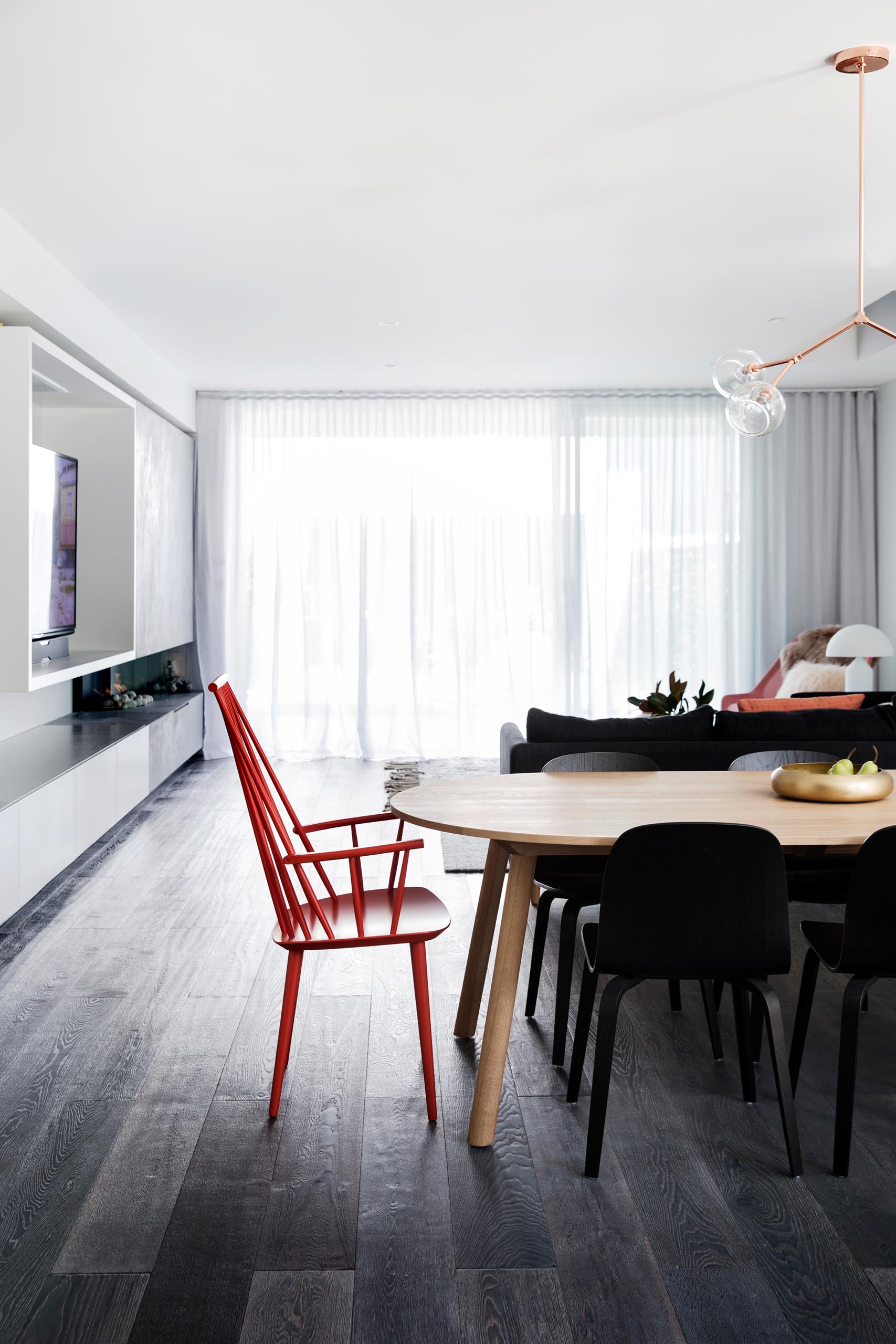 An open plan dining room with dark wood floor.