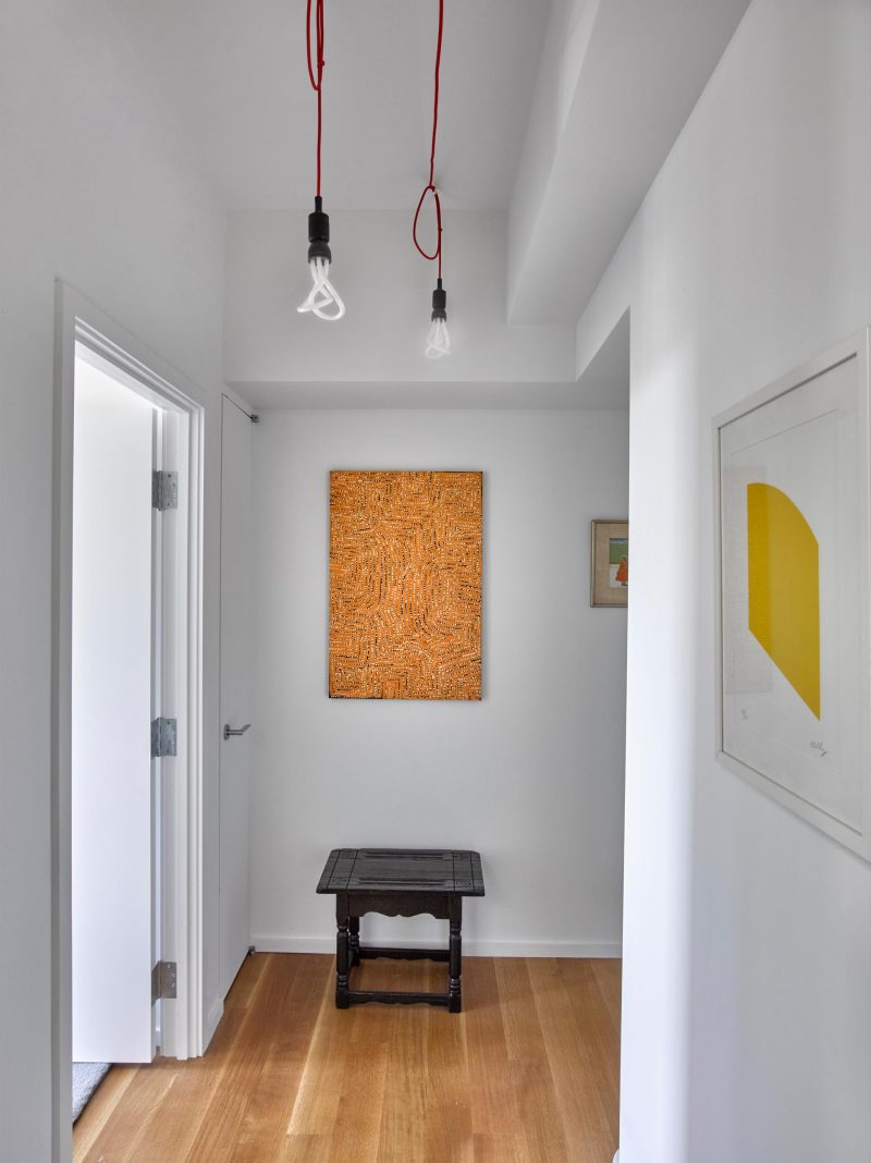 A modern and bright hallway filled with art.