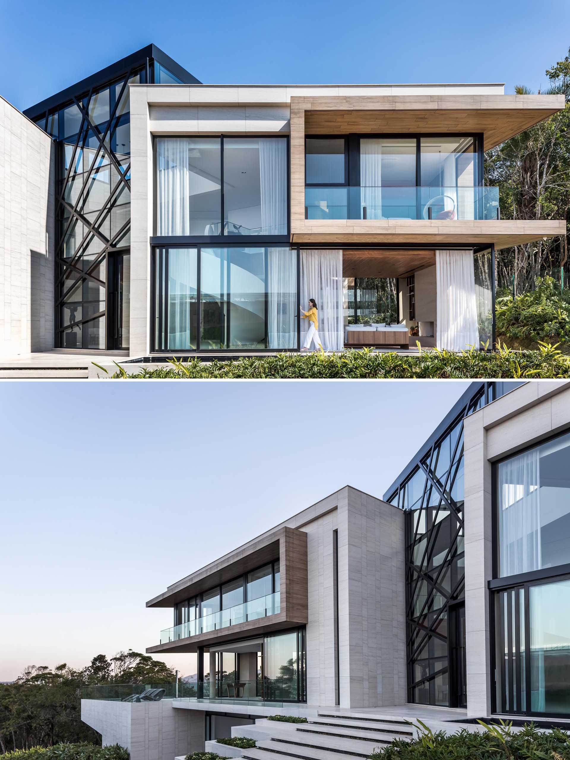 Steps leading up to the front door and a large double height atrium welcomes guests to this modern home.