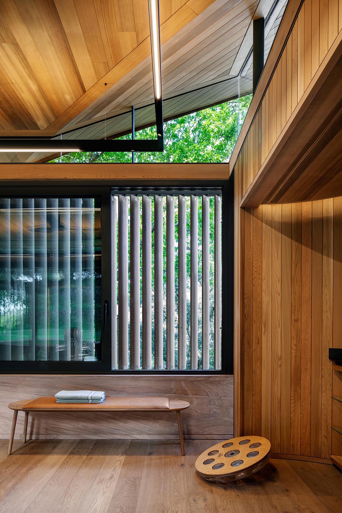 A home gym with aero-foil timber screens that provide privacy when needed.