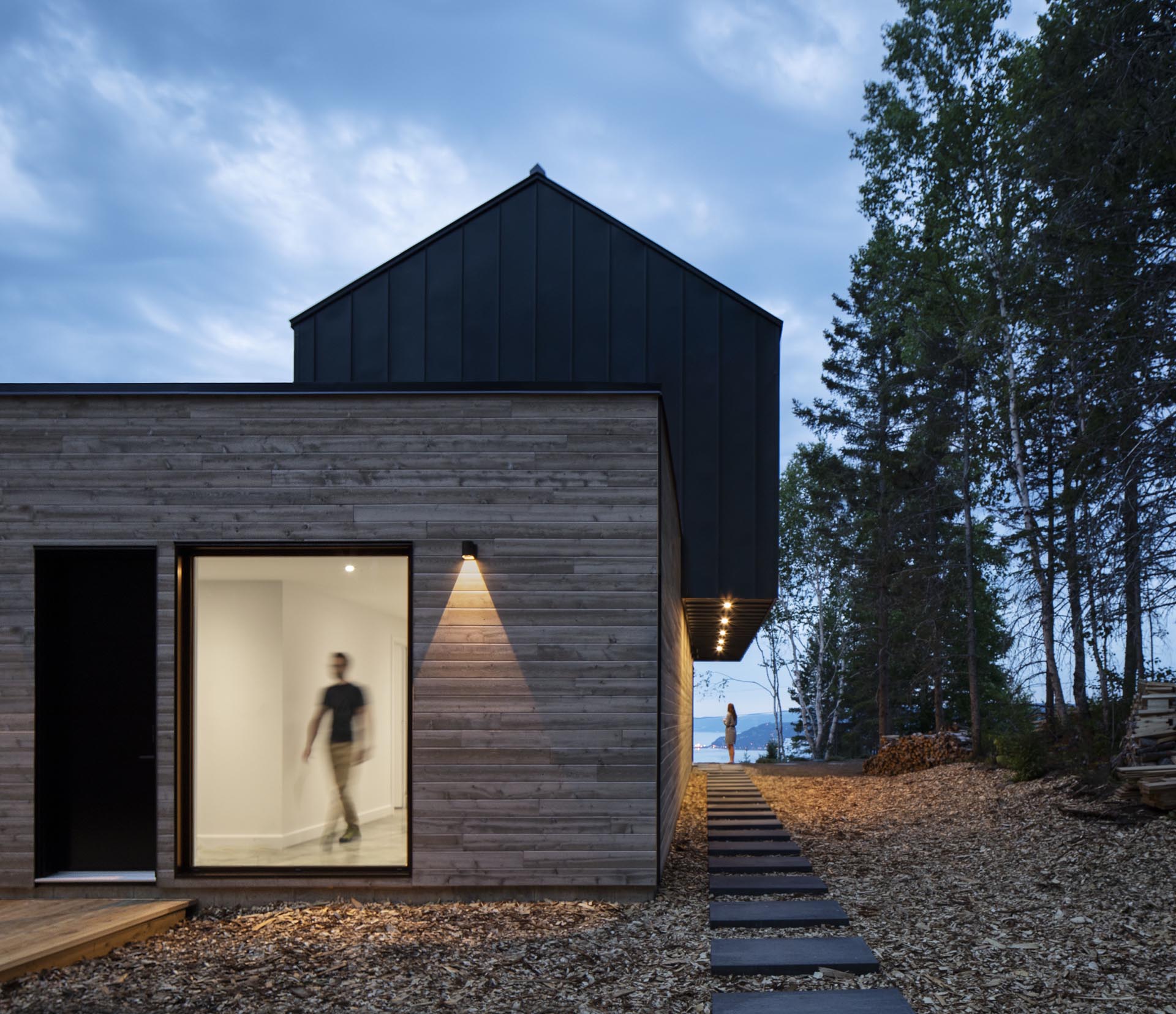 A modern home with a black metal and wood exterior.