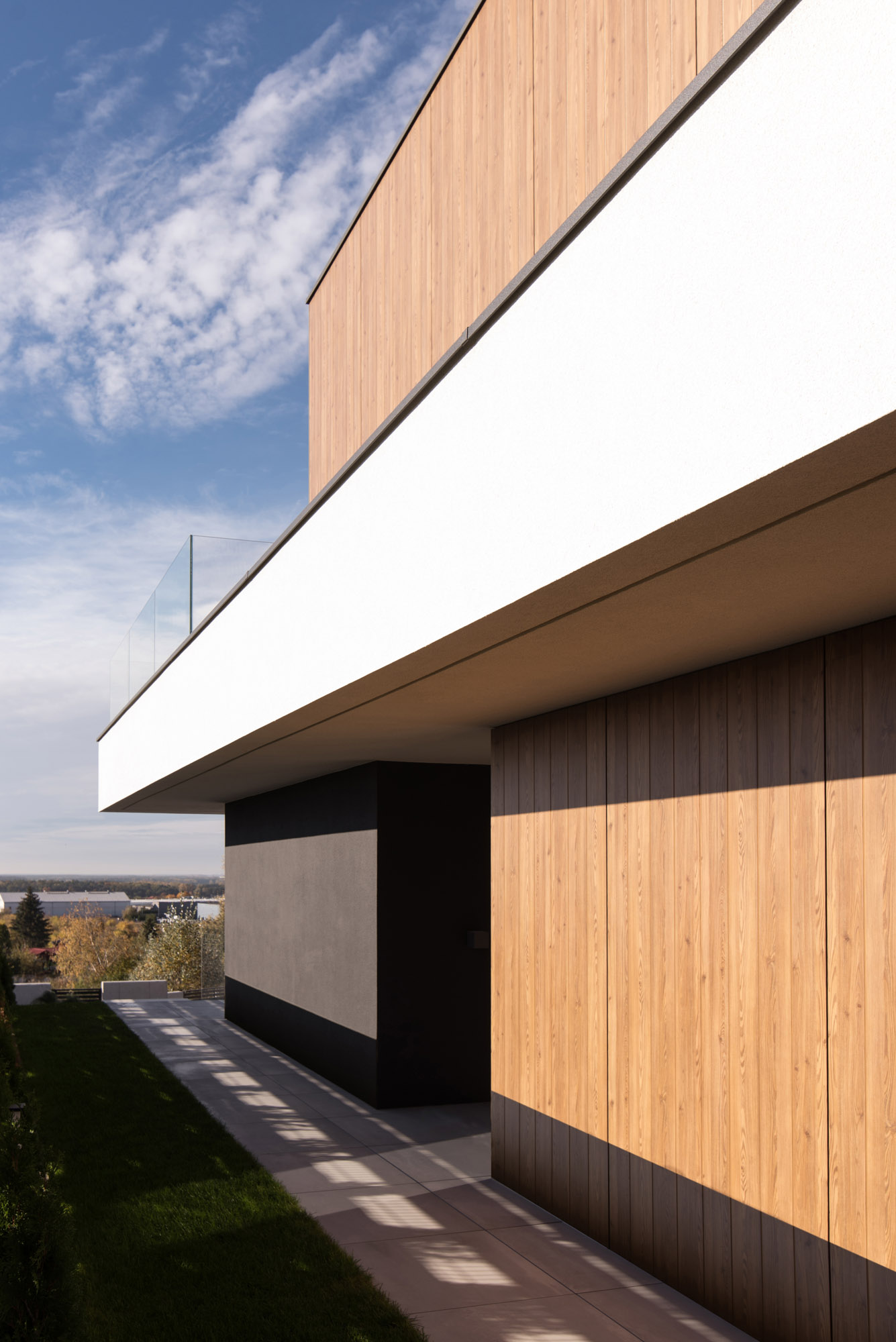 A modern home with a path that leads alongside the house.